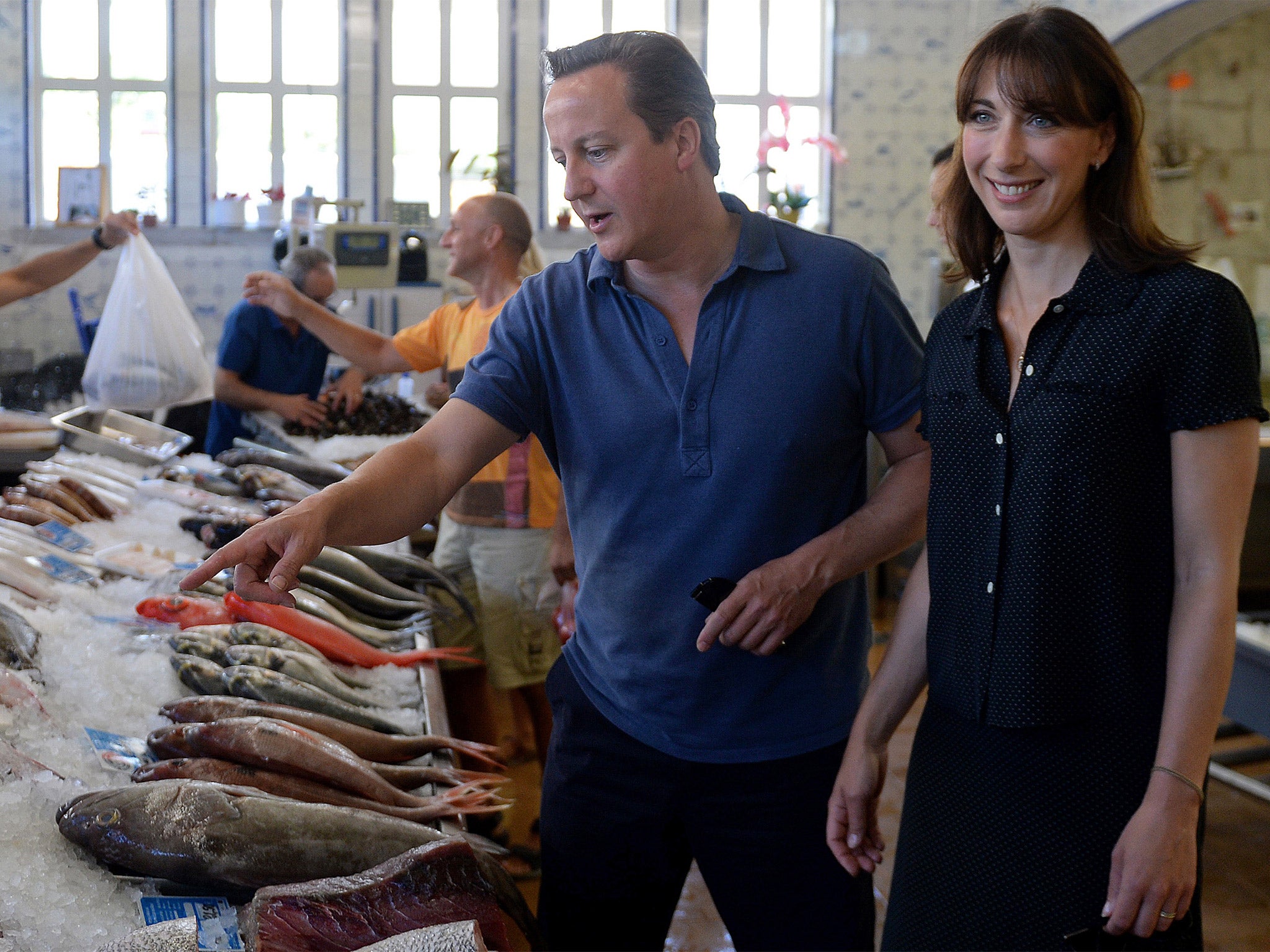 Prime Minister David Cameron and his wife Samantha are pictured as they visit a seafood market in Cascais in Portugal, on August 5, 2014