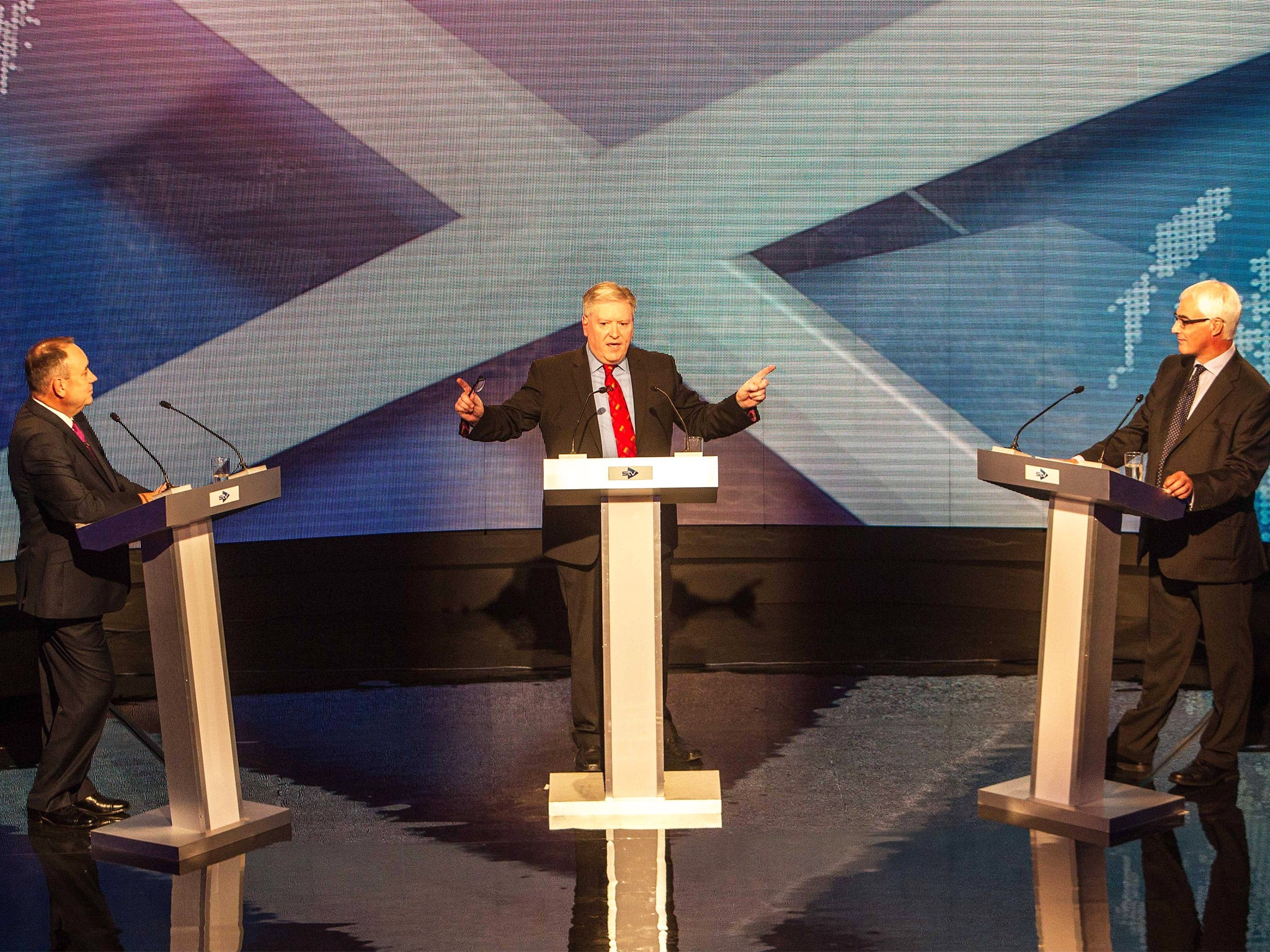 Host Bernard Ponsonby stands between Alex Salmond and Alistair Darling during the televised debate