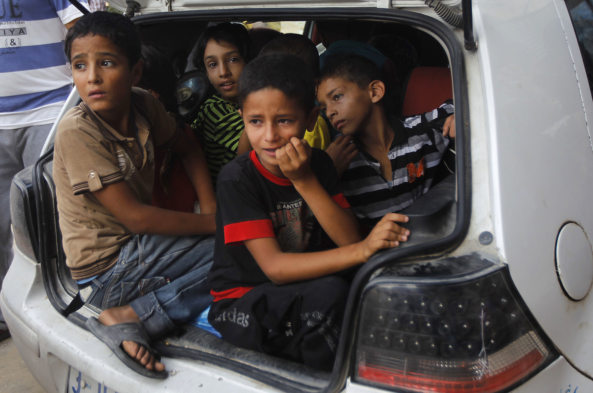 Palestinian families leave their neighborhood to a safer location as Israel's army continues shelling the area of Khan Yunis, in the southern Gaza Strip