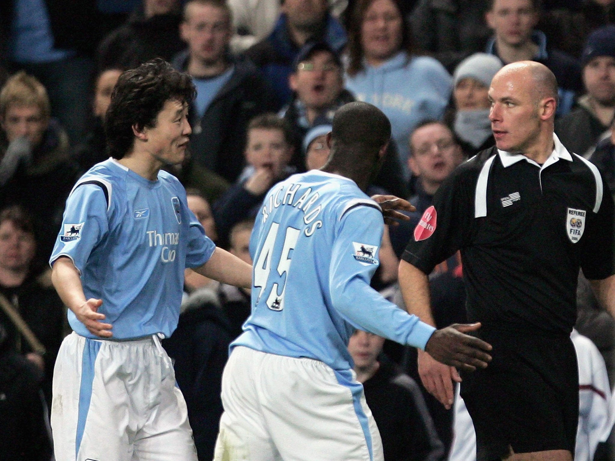 Howard Webb (right) sends off Manchester City defender Sun Jihai (left)