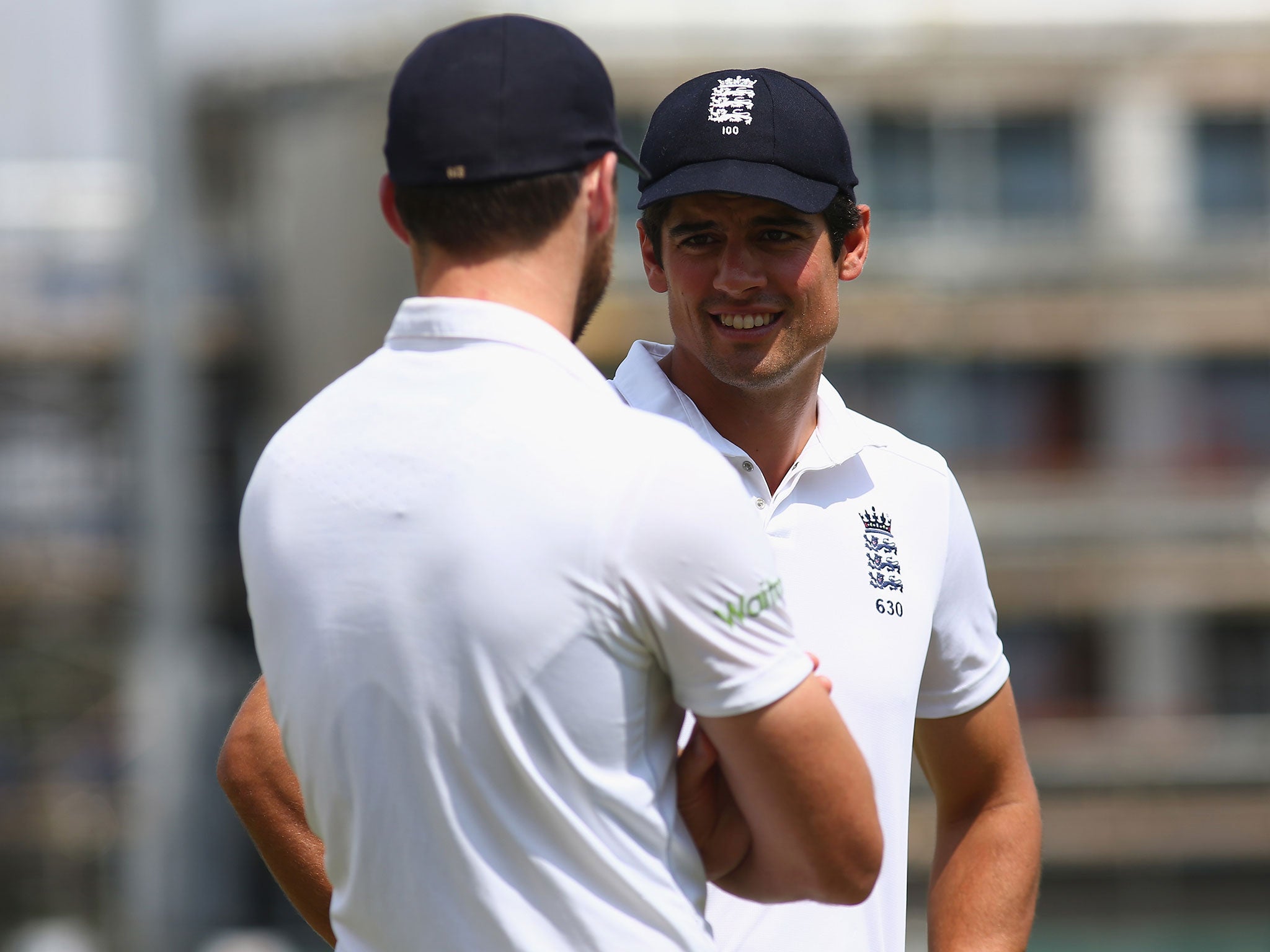 Alastair Cook and Jimmy Anderson speak on the field