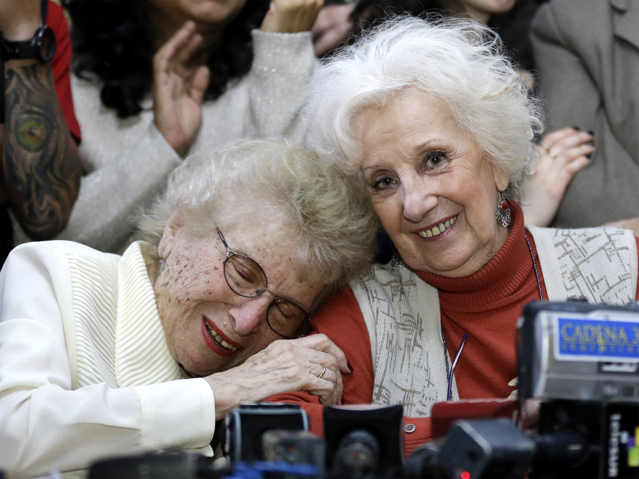 Human rights activist Estela de Carlotto (right) hugs Rosa de Roisinblit at a news conference in Buenos Aires