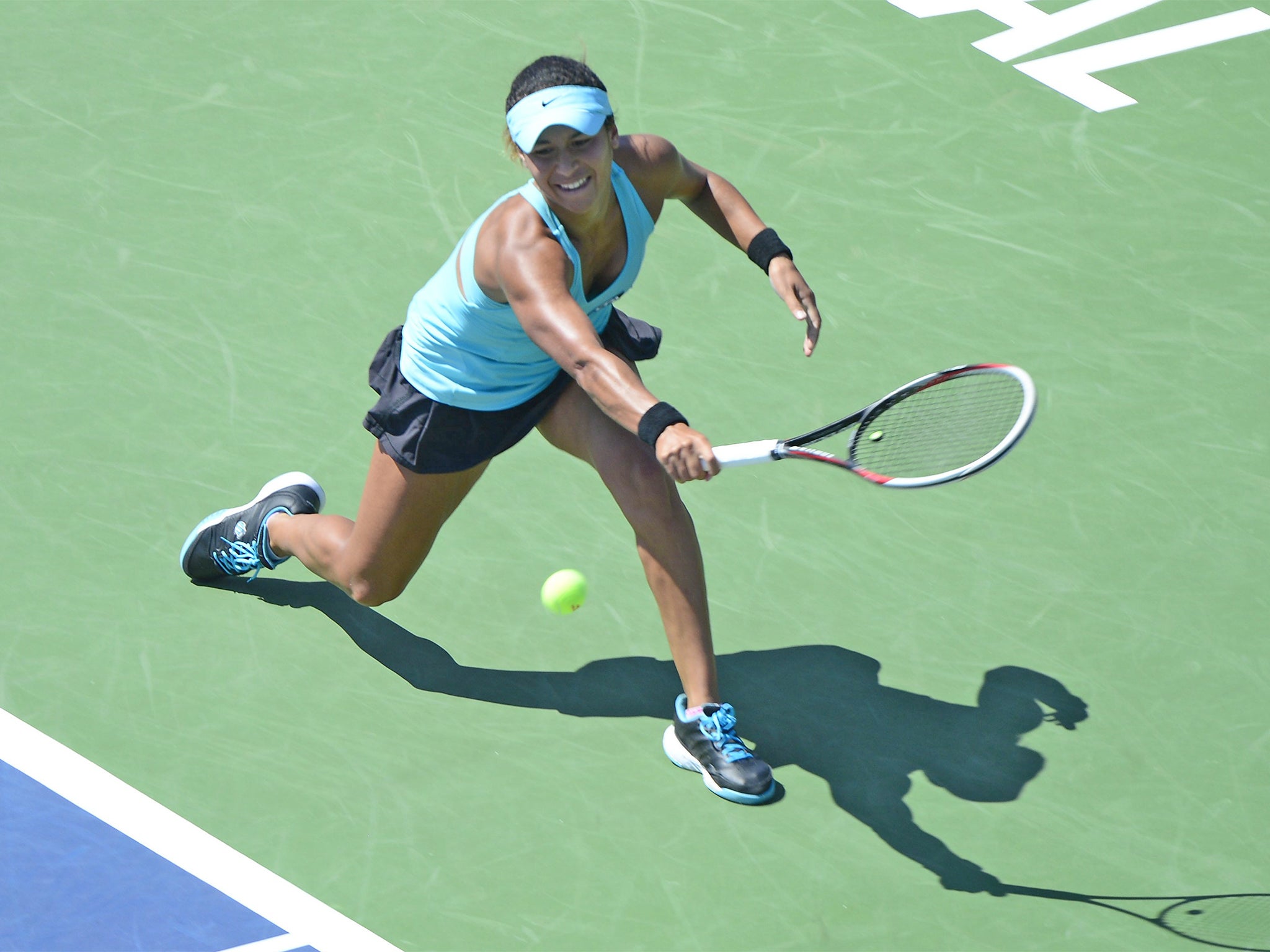 Heather Watson plays stretches for a backhand on her way to beating Dominika Cibulkova