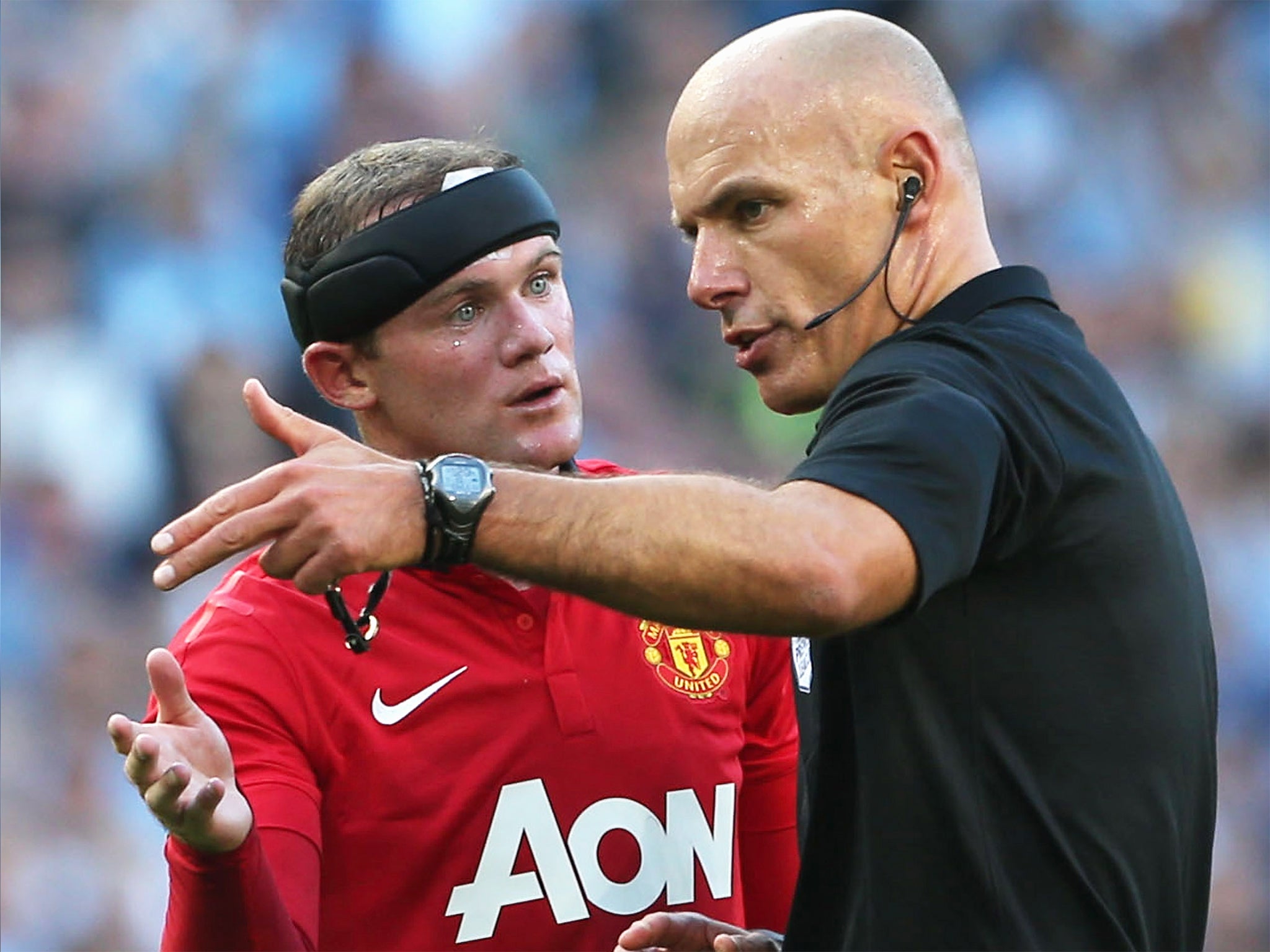 Howard Webb (right) explains a decision to Manchester United’s Wayne Rooney