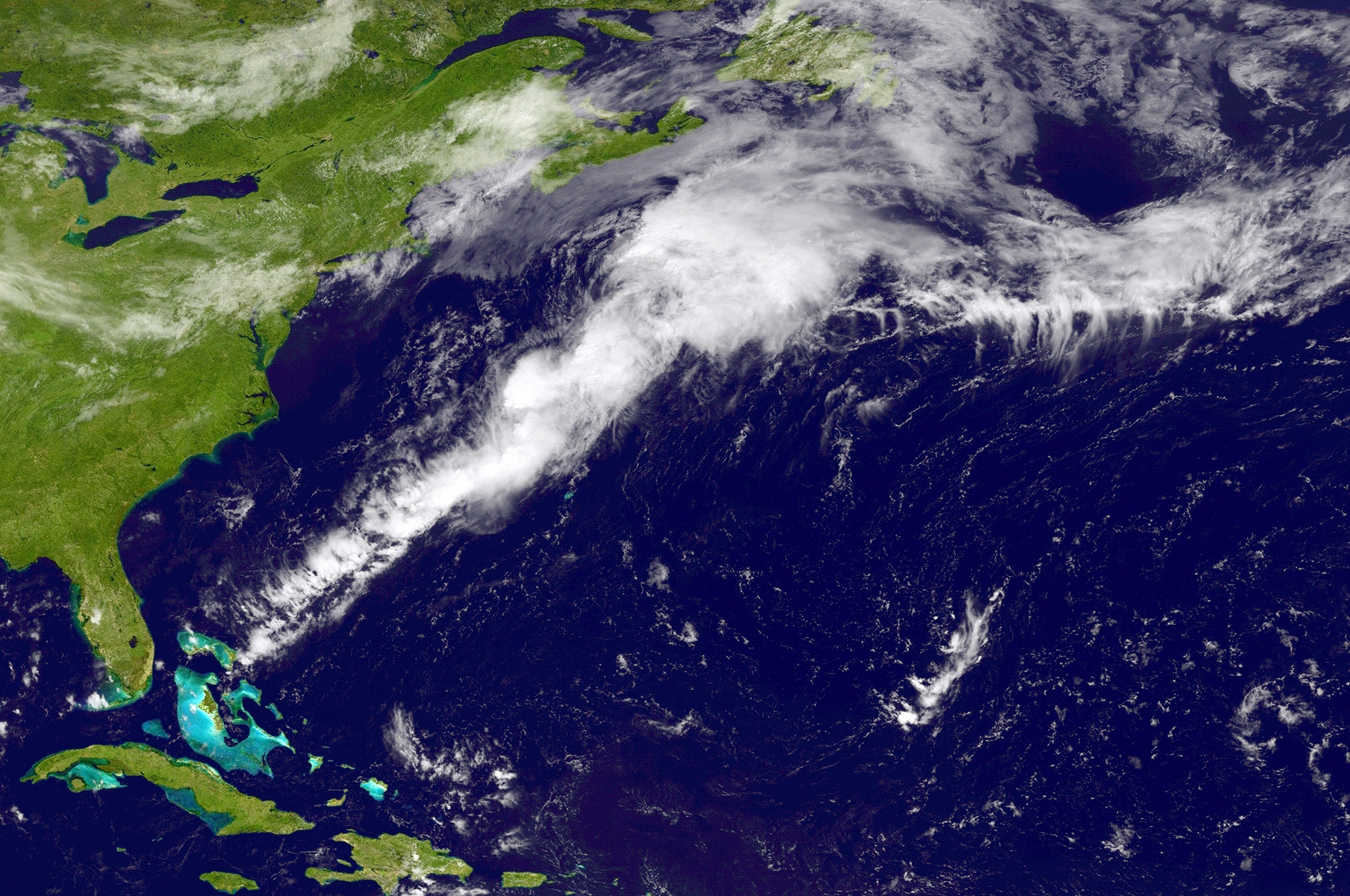 A weather system travels north and east in the Atlantic Ocean off the coast of the United States. The storm named Bertha, the second hurricane of the 2014 Atlantic hurricane season, is now expected to grow in size before becoming a post-tropical cyclone w