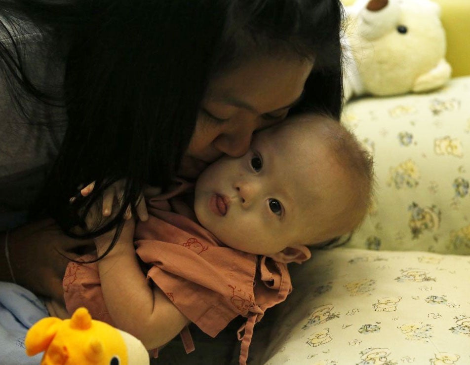 Child protection services in Australia have made contact with a couple accused of leaving a baby with Down’s syndrome with its Thai surrogate mother, taking only his healthy twin sister.