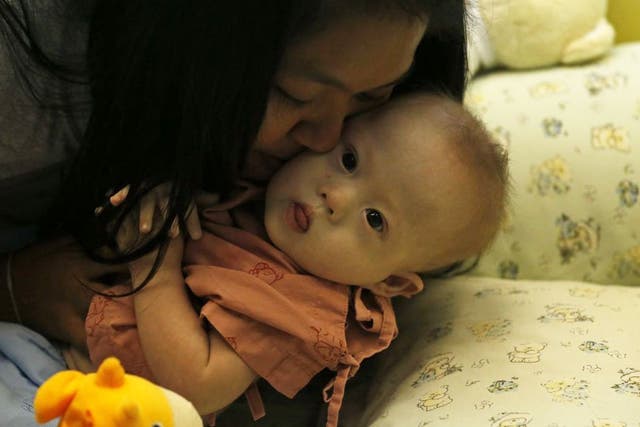 Child protection services in Australia have made contact with a couple accused of leaving a baby with Down’s syndrome with its Thai surrogate mother, taking only his healthy twin sister. 