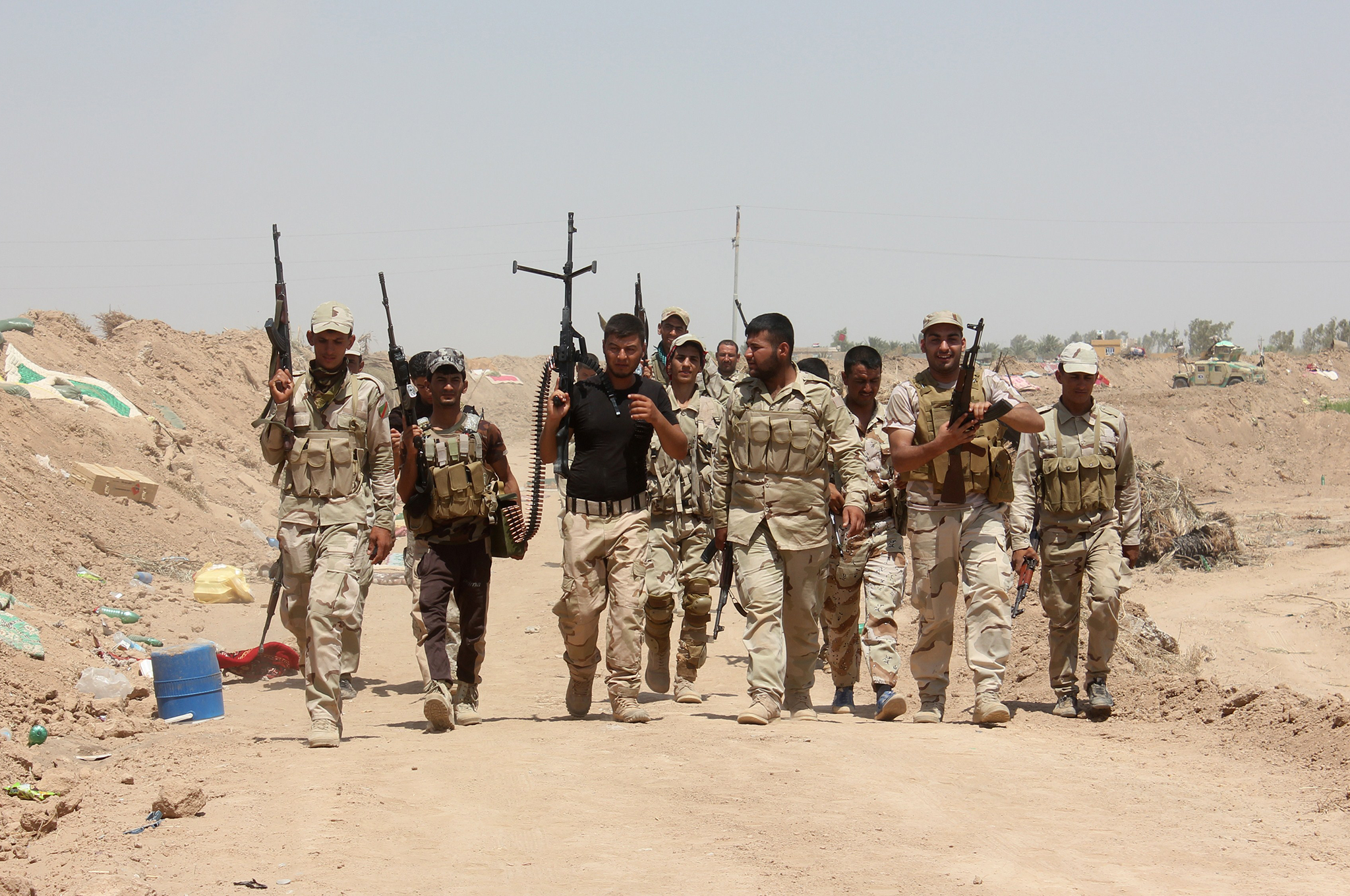 Iraqi volunteers who joined government forces to fight against Sunni jihadist militants of the Islamic State (IS) hold a position at a checkpoint in Udhaim