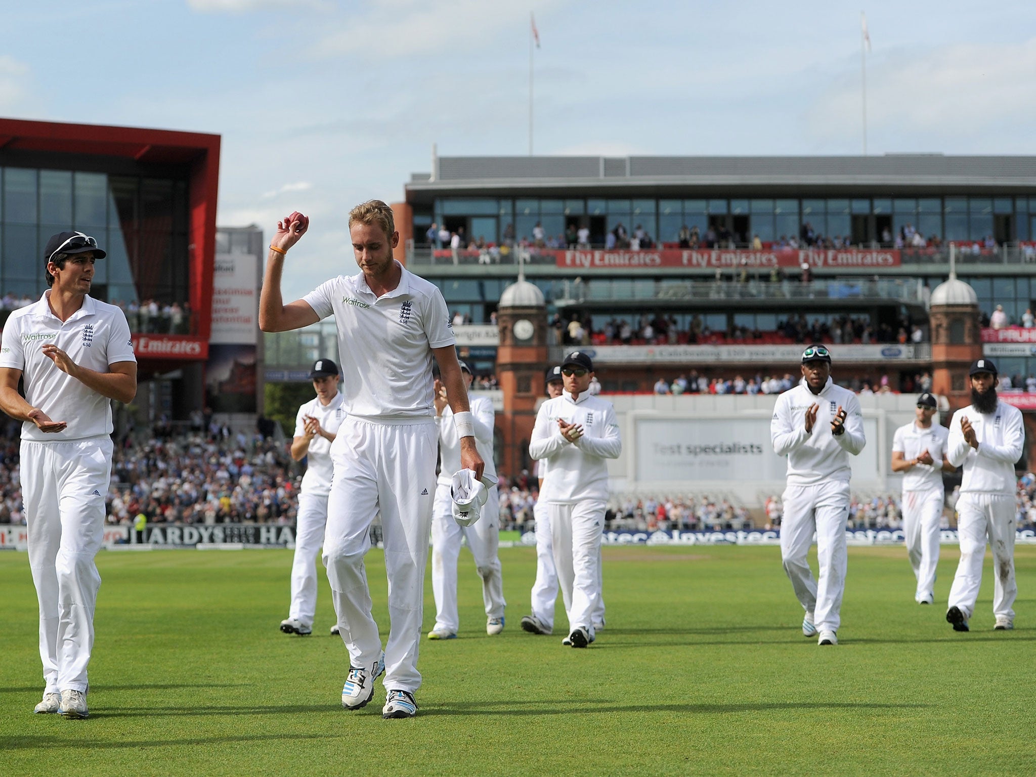 Stuart Broad is applauded from the field by his England team-mates after his remarkable spell of bowling at Old Trafford when he took six wickets for 25 runs from 13 overs