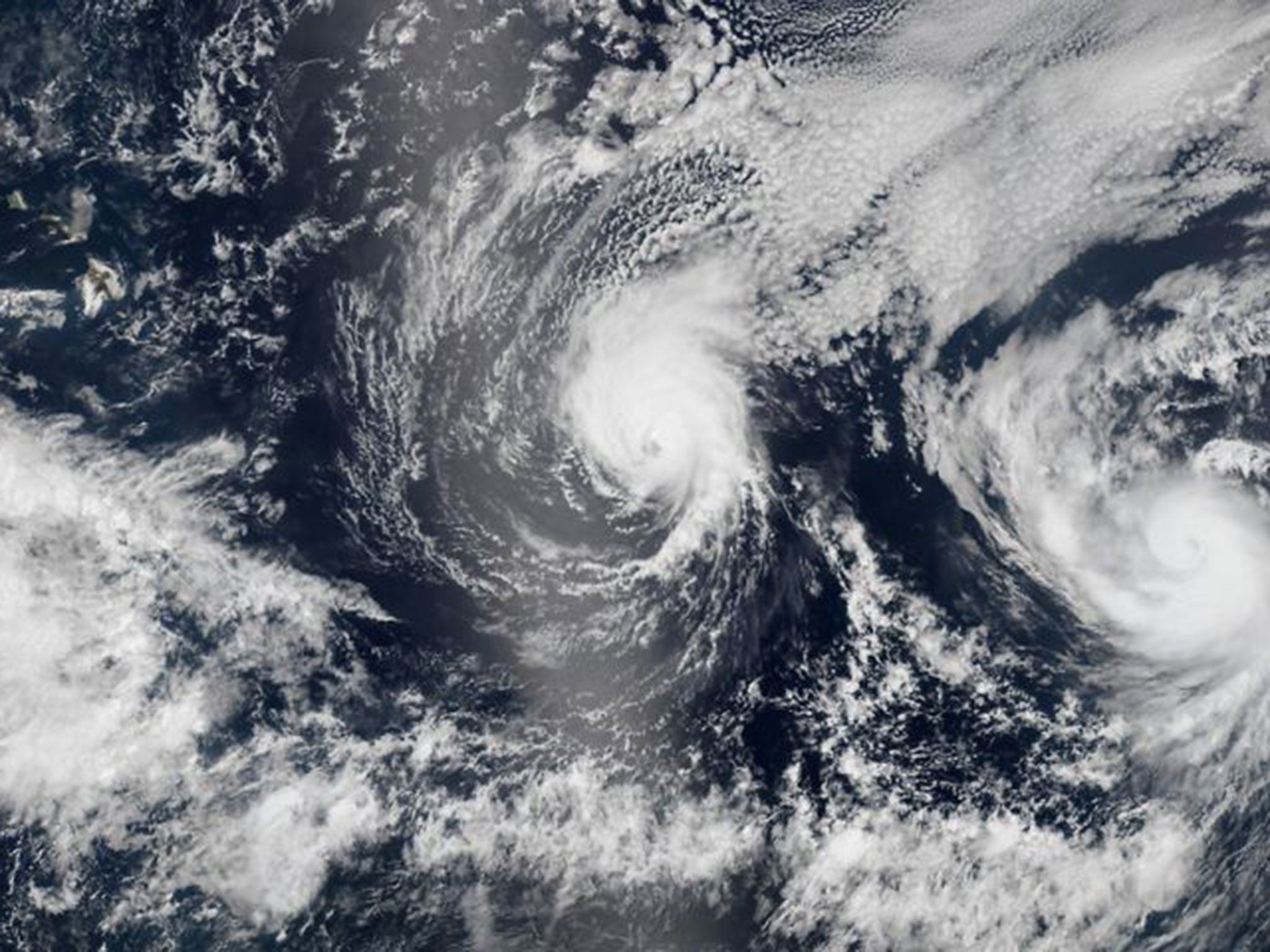 Two tropical Pacific Ocean hurricanes - Iselle at center and Julio at right - bearing down on Hawaii, top left. Hurricane Iselle is expected to reach Hawaii Thursday night, Aug. 7, 2014.