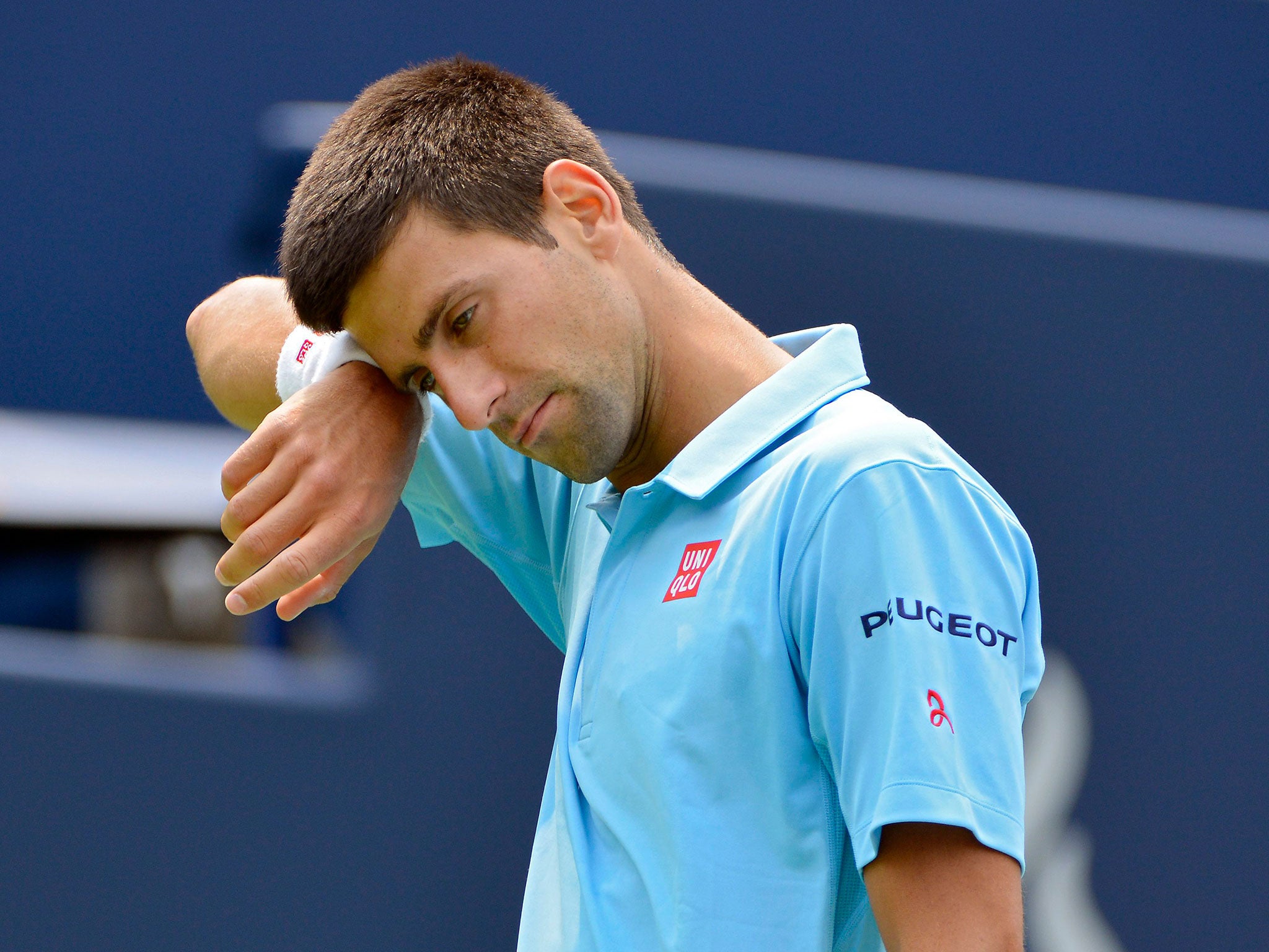 Novak Djokovic cuts a frustrated figure on his way to defeat at the Toronto Masters