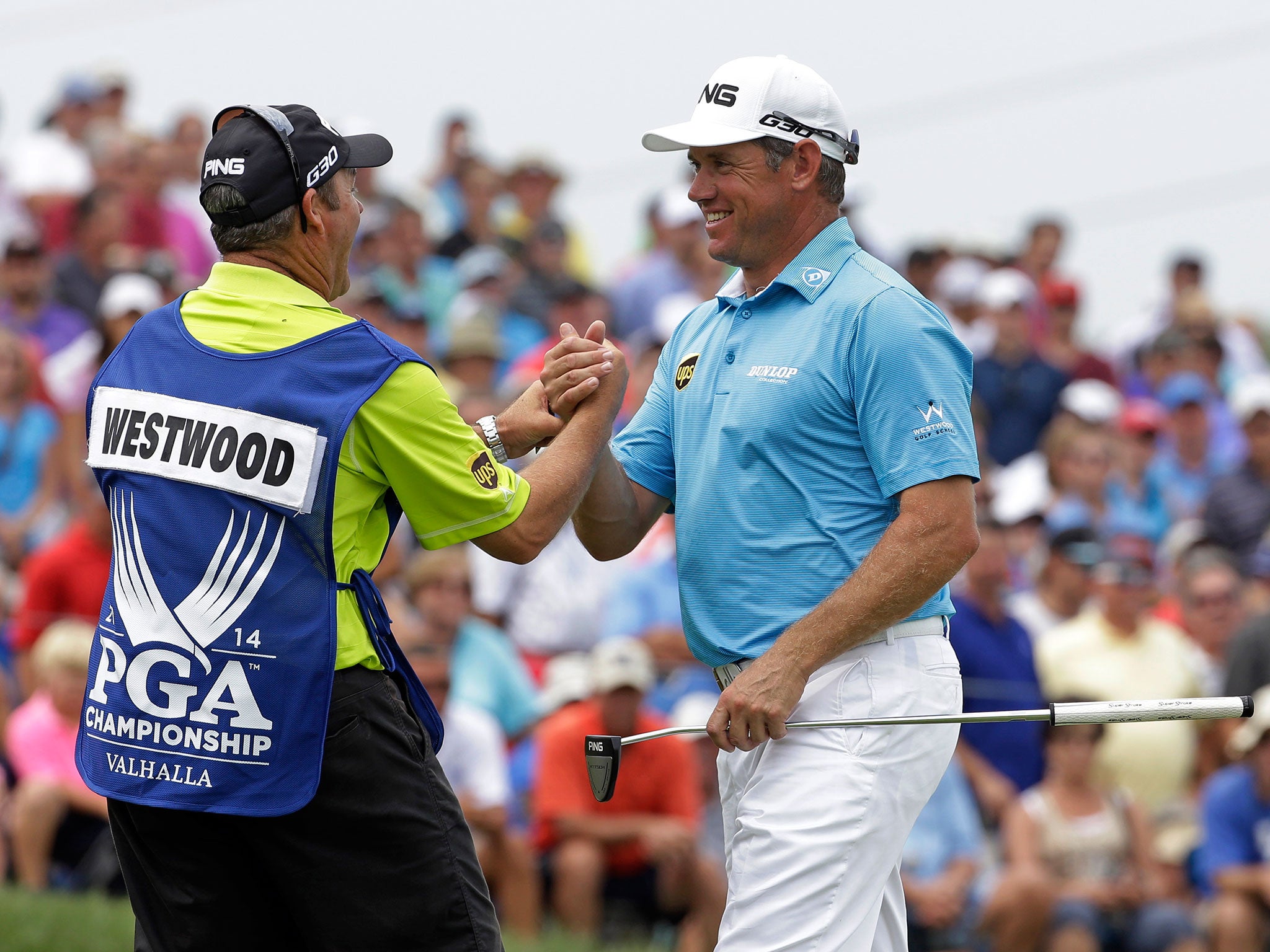 Lee Westwood, right, celebrates completing his round of 65