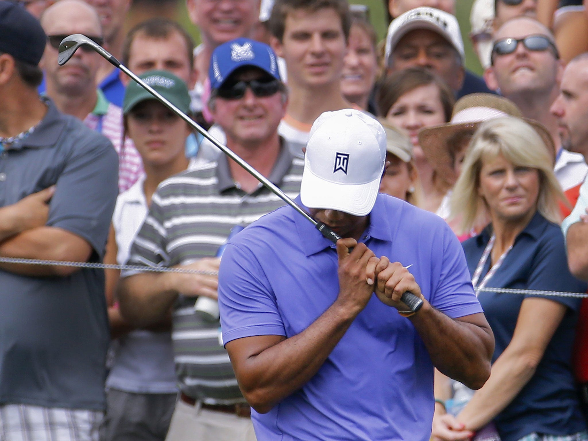 Tiger Woods reacts to a poor chip on the first hole