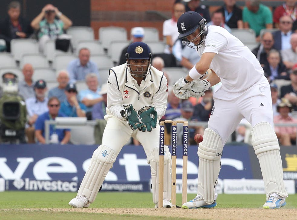 MS Dhoni looks on as Joe Root plays a shot during the fourth Test
