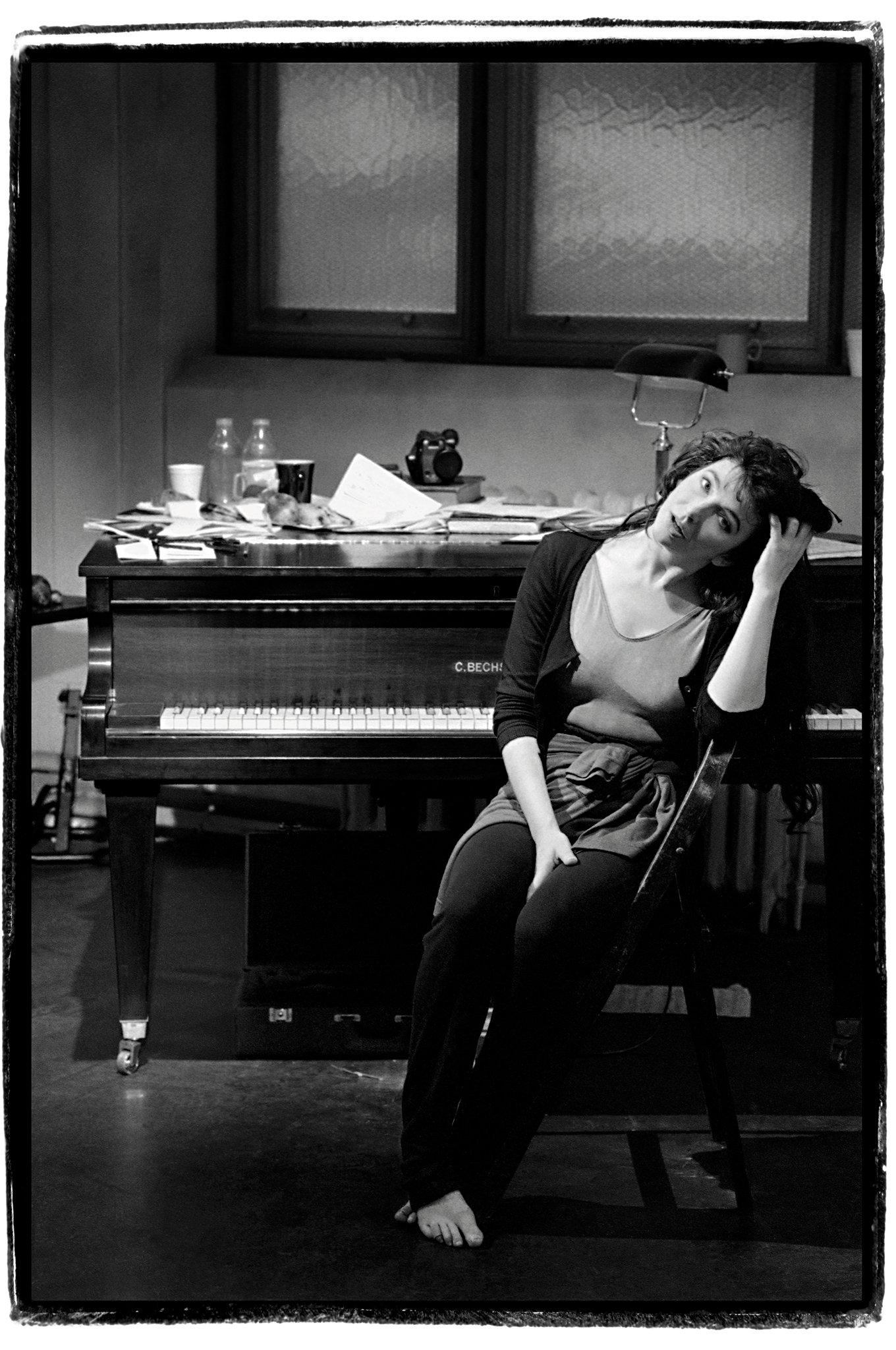 Kate Bush sitting at her piano