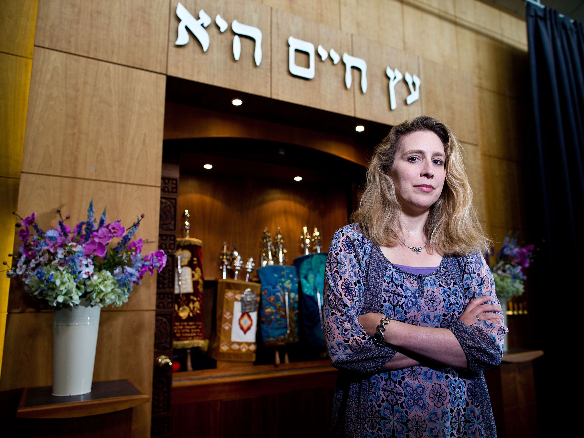 Rabbi Miriam Berger of the Finchley Reform Synagogue, standing in front of the Torah Ark