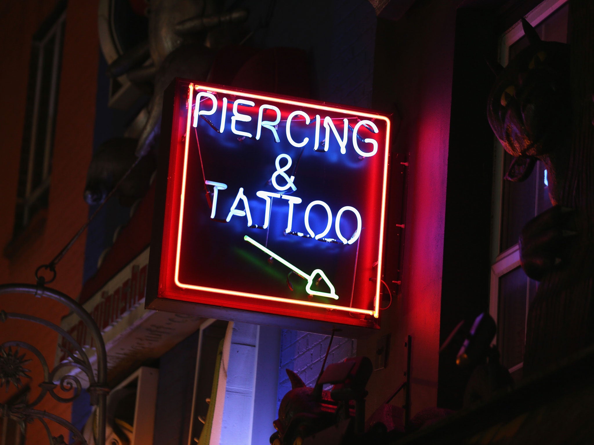 A sign advertises tattooing and piercing near Camden Market