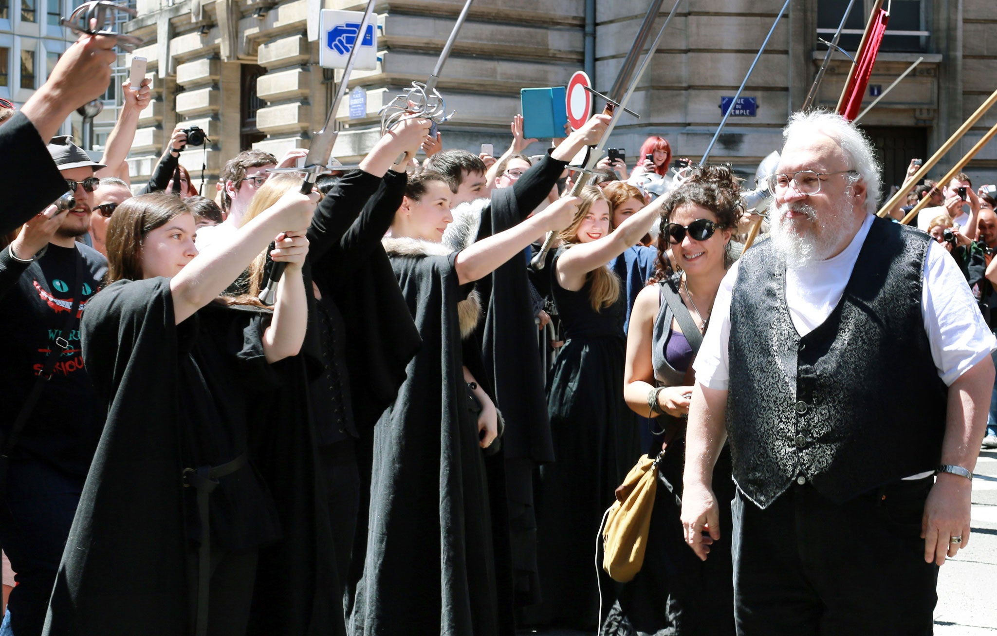 George RR Martin is greeted by fans before attending a book signing in France