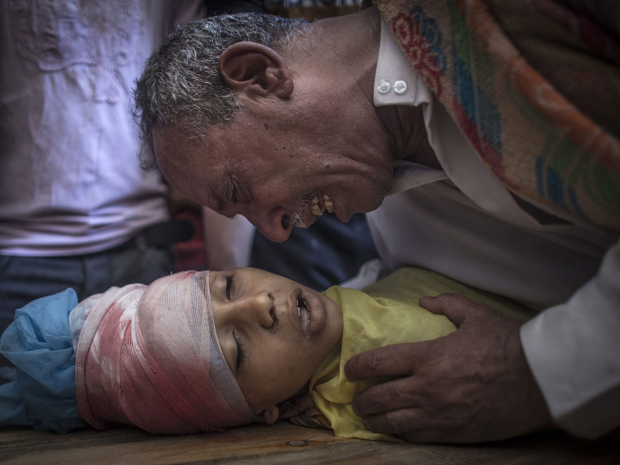 The father of 10-year-old Ibraheem al-Dawawsa cries over the dead body of his son in Gaza City