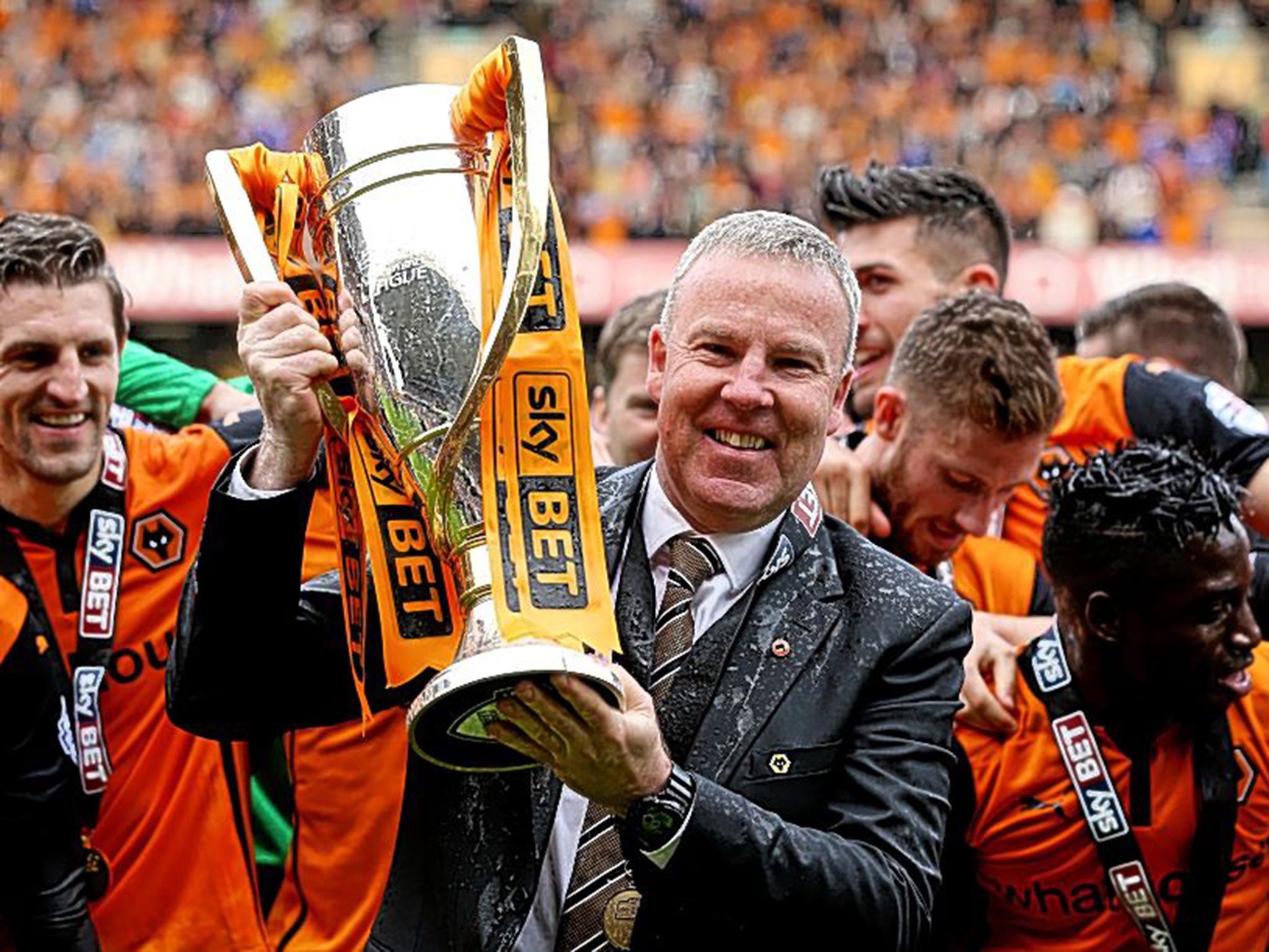 Kenny Jackett holds the League One trophy, won by Wolves with 103 points