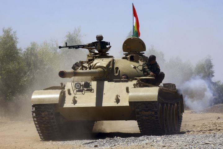 Kurdish peshmerga troops patrol in a tank during an operation against Islamic State militants in Makhmur, on the outskirts of the province of Nineveh August 7, 2014.