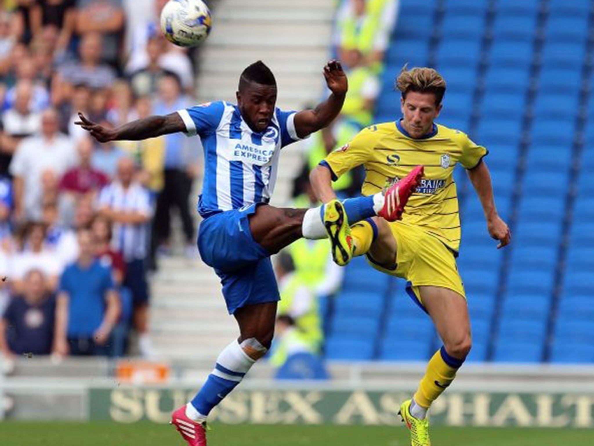 Kazenga Lua Lua challenges Sam Hutchinson during Brighton's defeat to Sheffield Wednesday