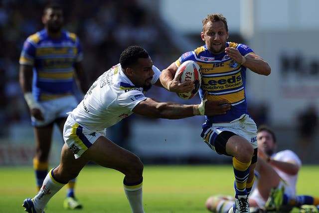 Rob Burrow evades the clutches of Warrington centre Ryan Atkins during Leeds' 24-16 victory