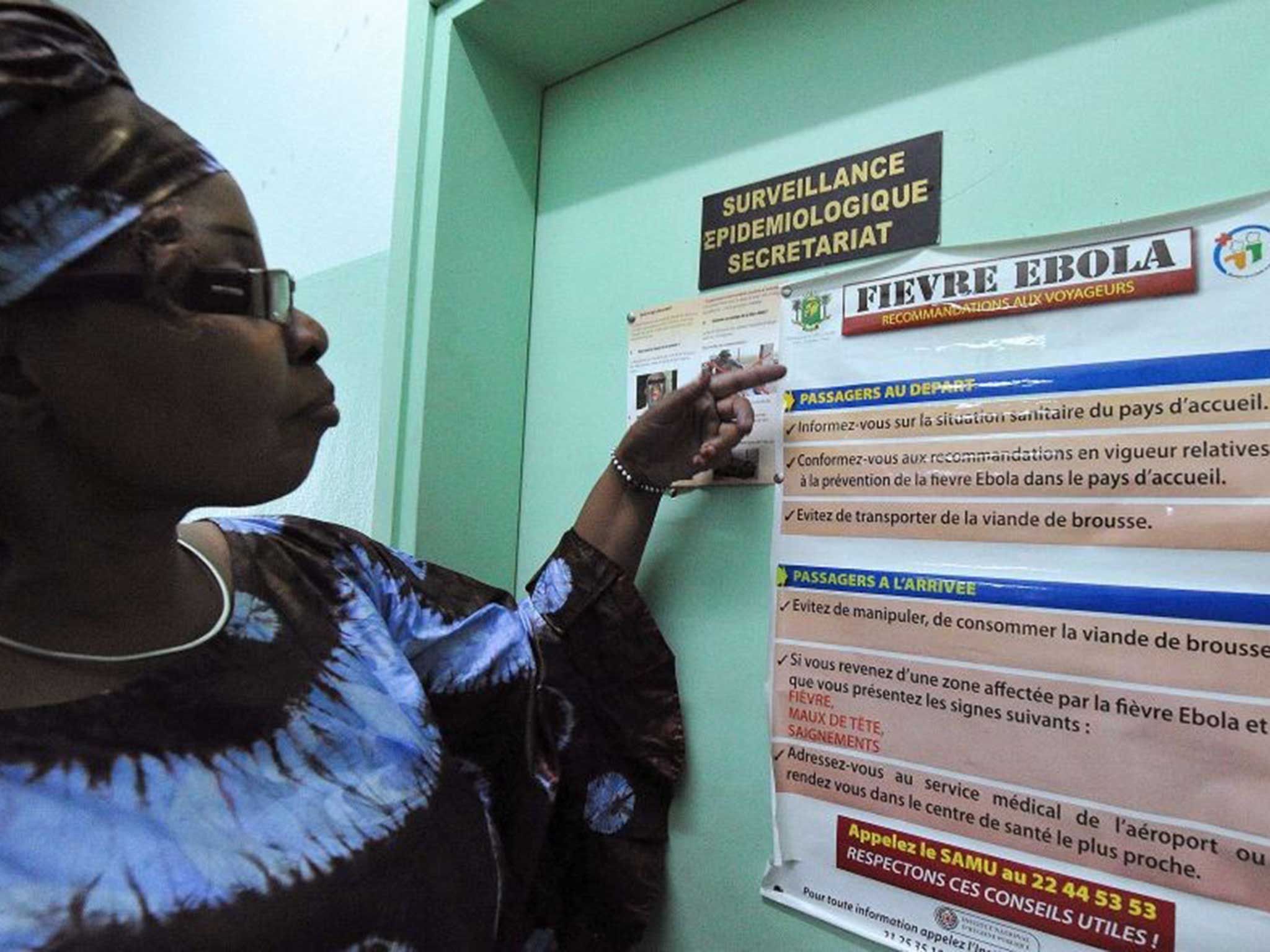 A woman checks a board containing travel information