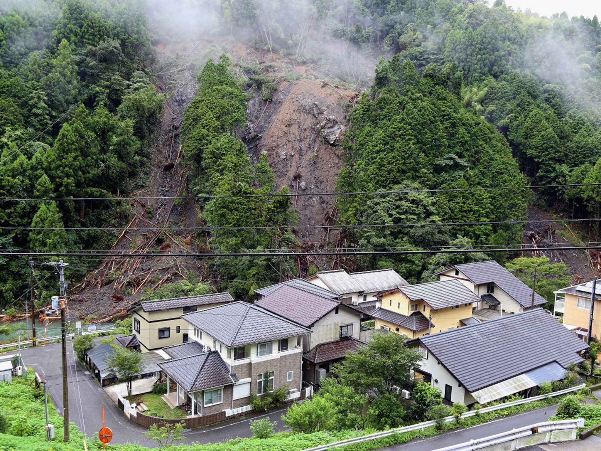 The torrential rain and winds of 110 mph led to landslides, travel disruptions and the evacuation of 1.5m people from their homes (Getty Images)