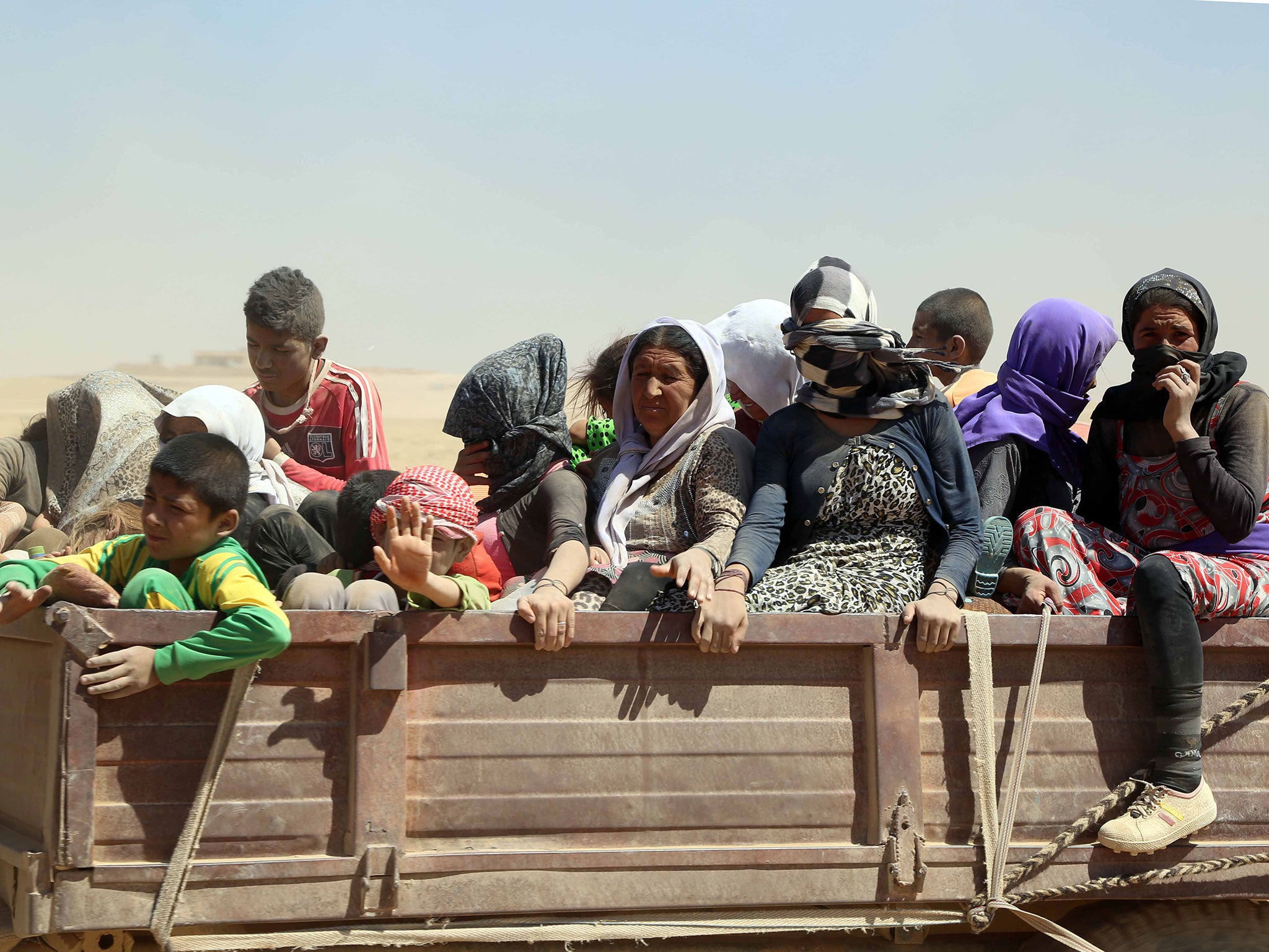 Yazidis who had fled to the Sinjar mountains to escape Isis fighters are brought to safety in Mosul by Kurdish Peshmerga forces