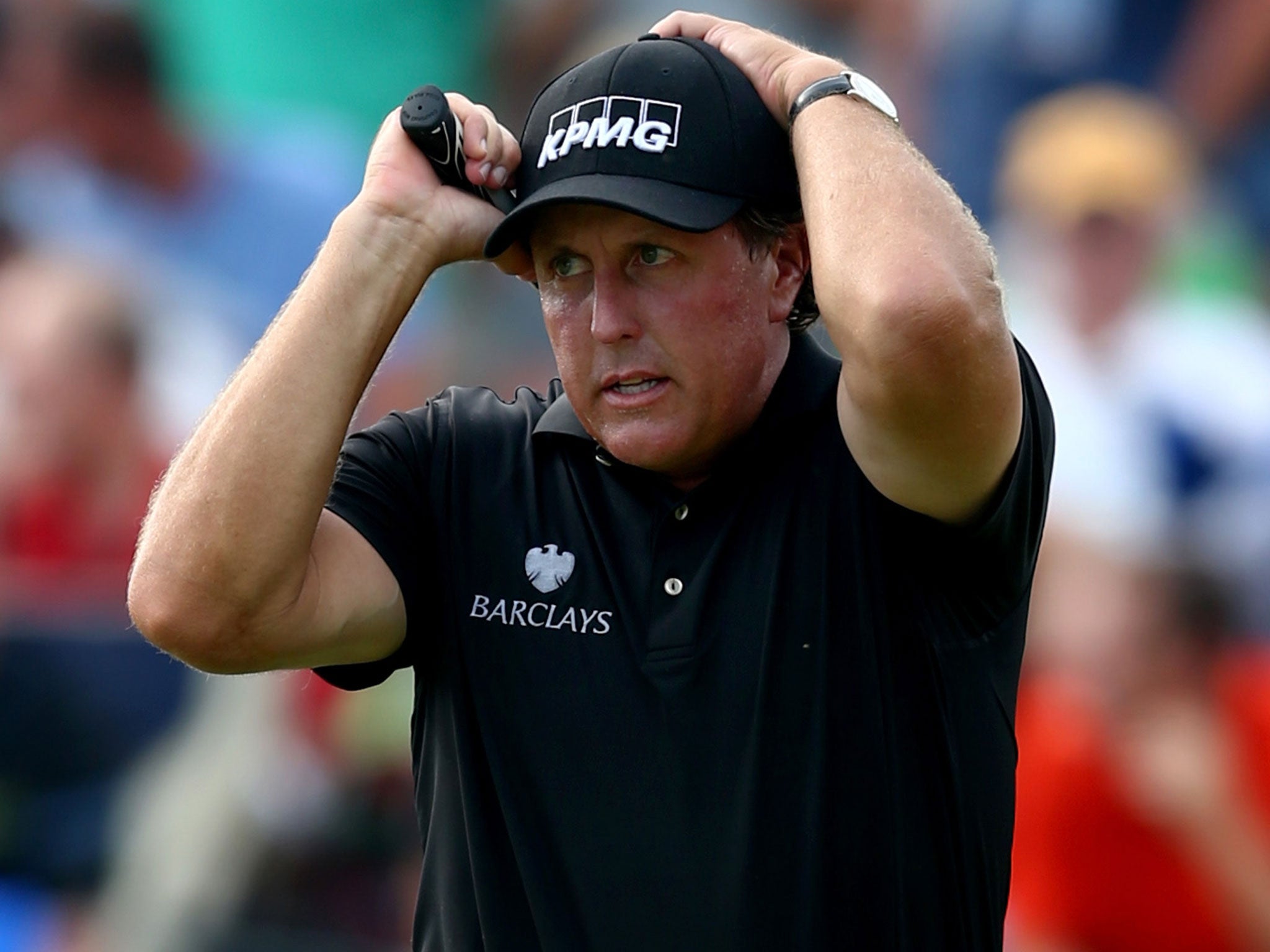 Phil Mickelson reacts after narrowly missing an eagle putt on the tenth