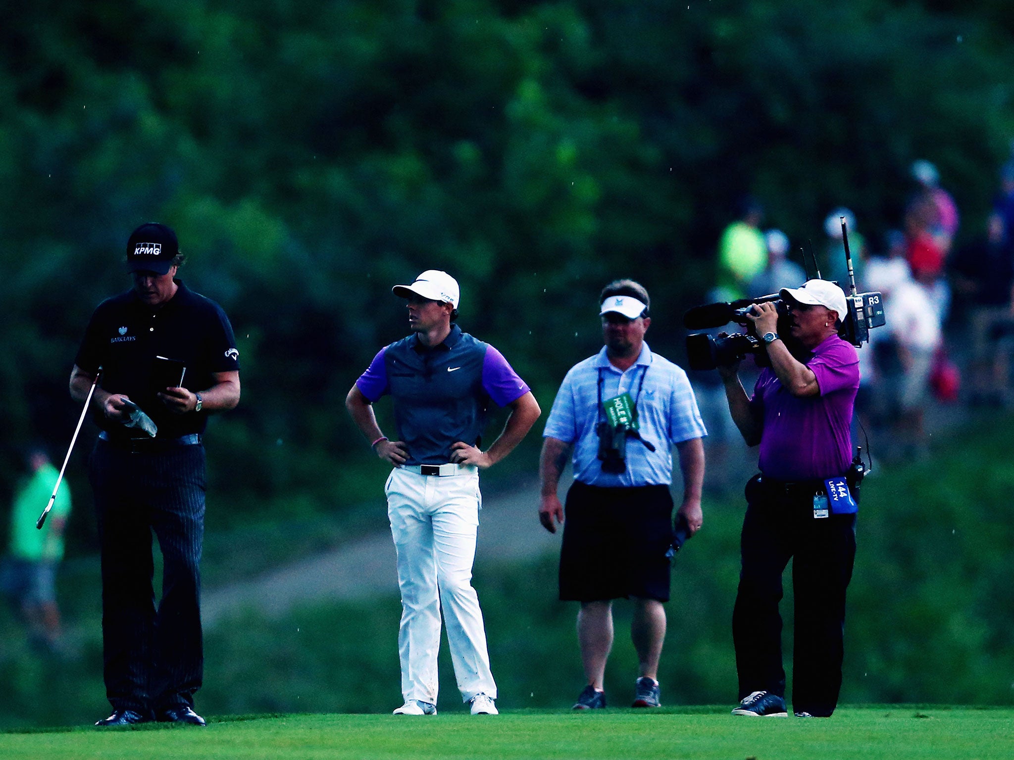 Phil Mickelson and Rory McIlroy stand together during the final round of the US PGA Championship