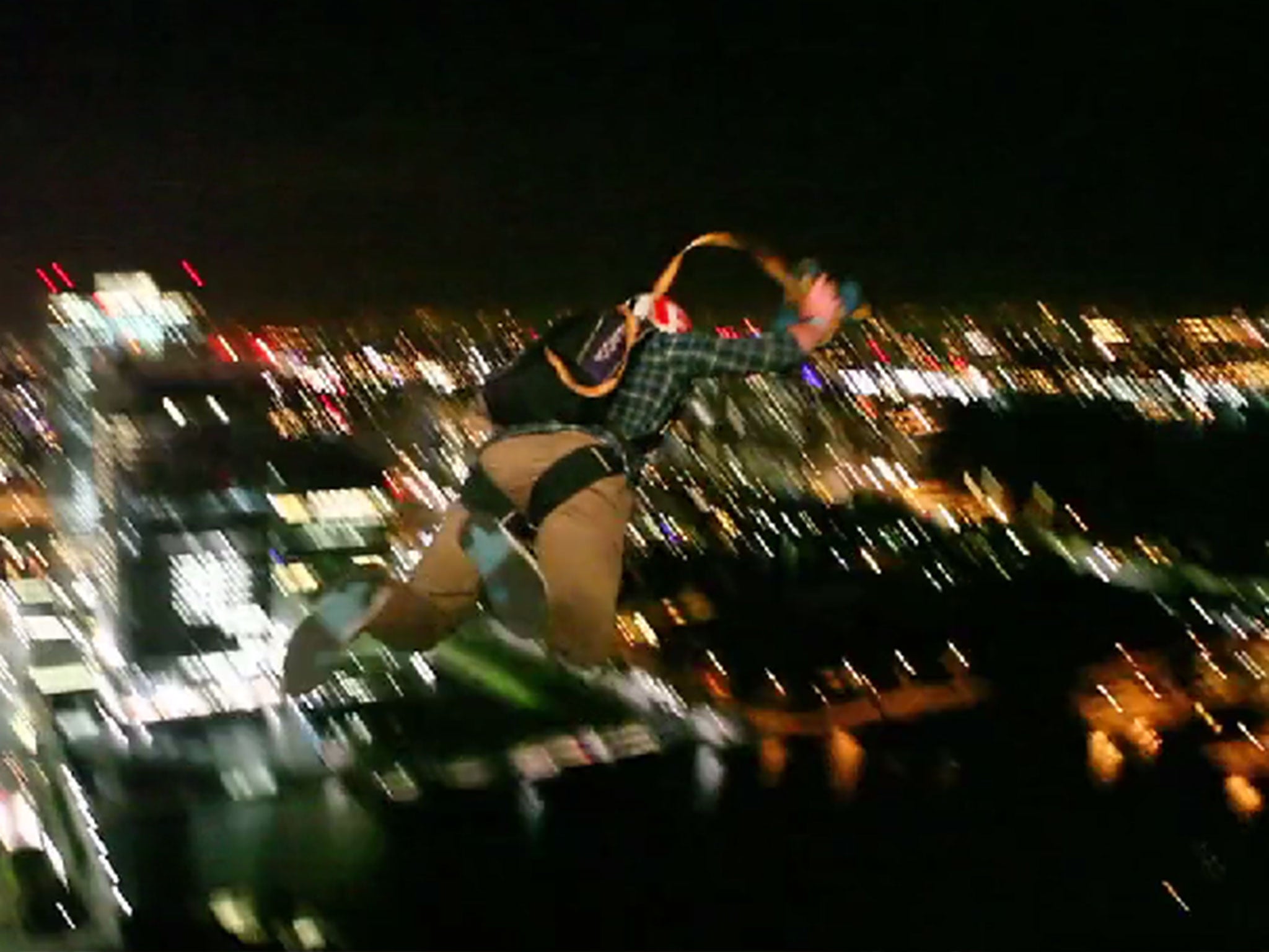 A pair of base jumpers throw themselves from the top of Canary Wharf.