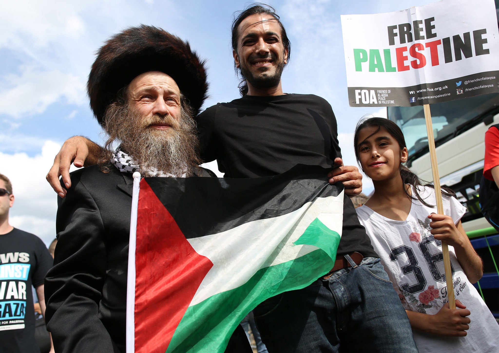 A religious Jewish man stands with pro-Palestinian supporters during the rally in Hyde Park on 9 August 9