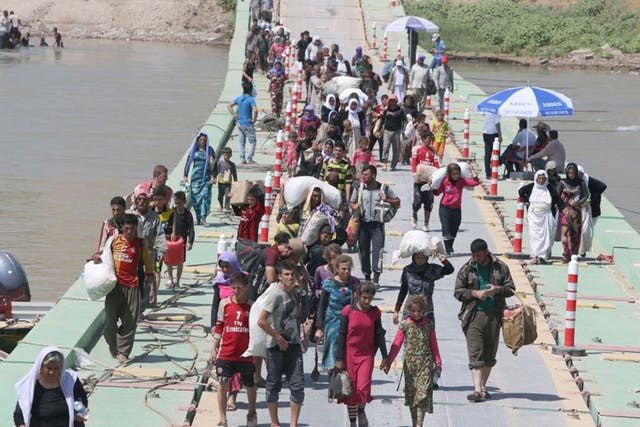 Iraqis from the Yazidi community at the Iraqi-Syrian border at Fishkhabur, where thousands have fled 