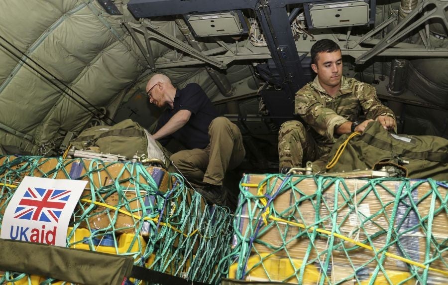 Bob Gibbons of the UK Department for International Development, left, doing final checks on humanitarian aid to be airlifted to stranded civilians fleeing militants in northern Iraq