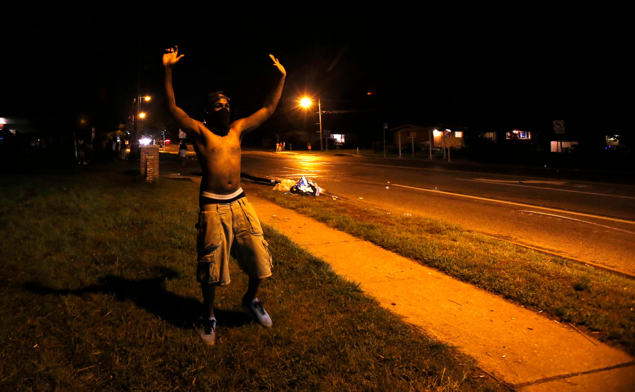 A demonstrator raises his hands in front of of a police officer in Ferguson, Missouri August 11, 2014.