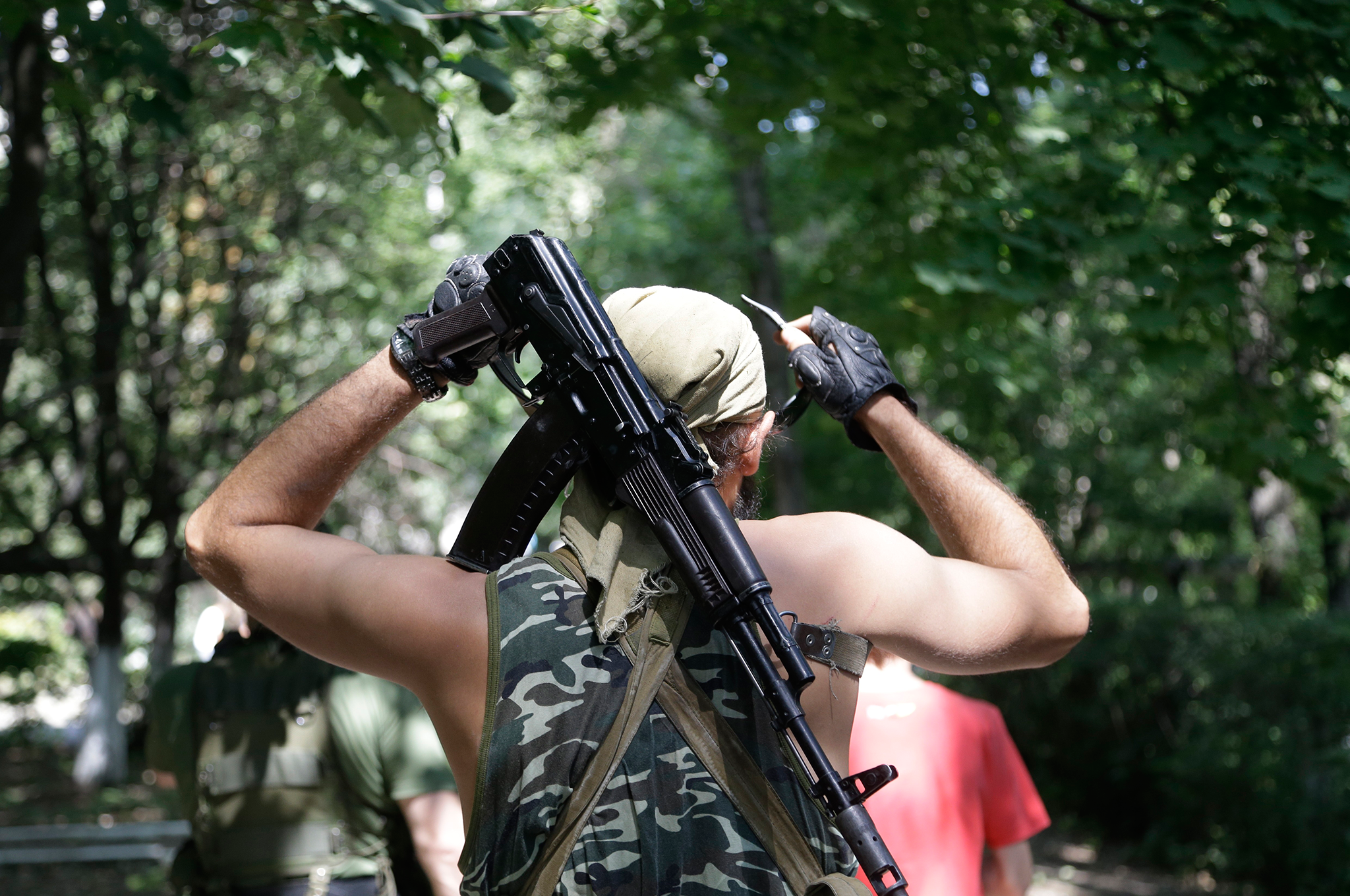 A Pro-Russian rebel adjusts his weapon in Donetsk, eastern Ukraine. Air strikes and artillery fire between pro-Russian separatists and Ukrainian troops in the eastern city of Donetsk have brought the violence closer than ever to the city center