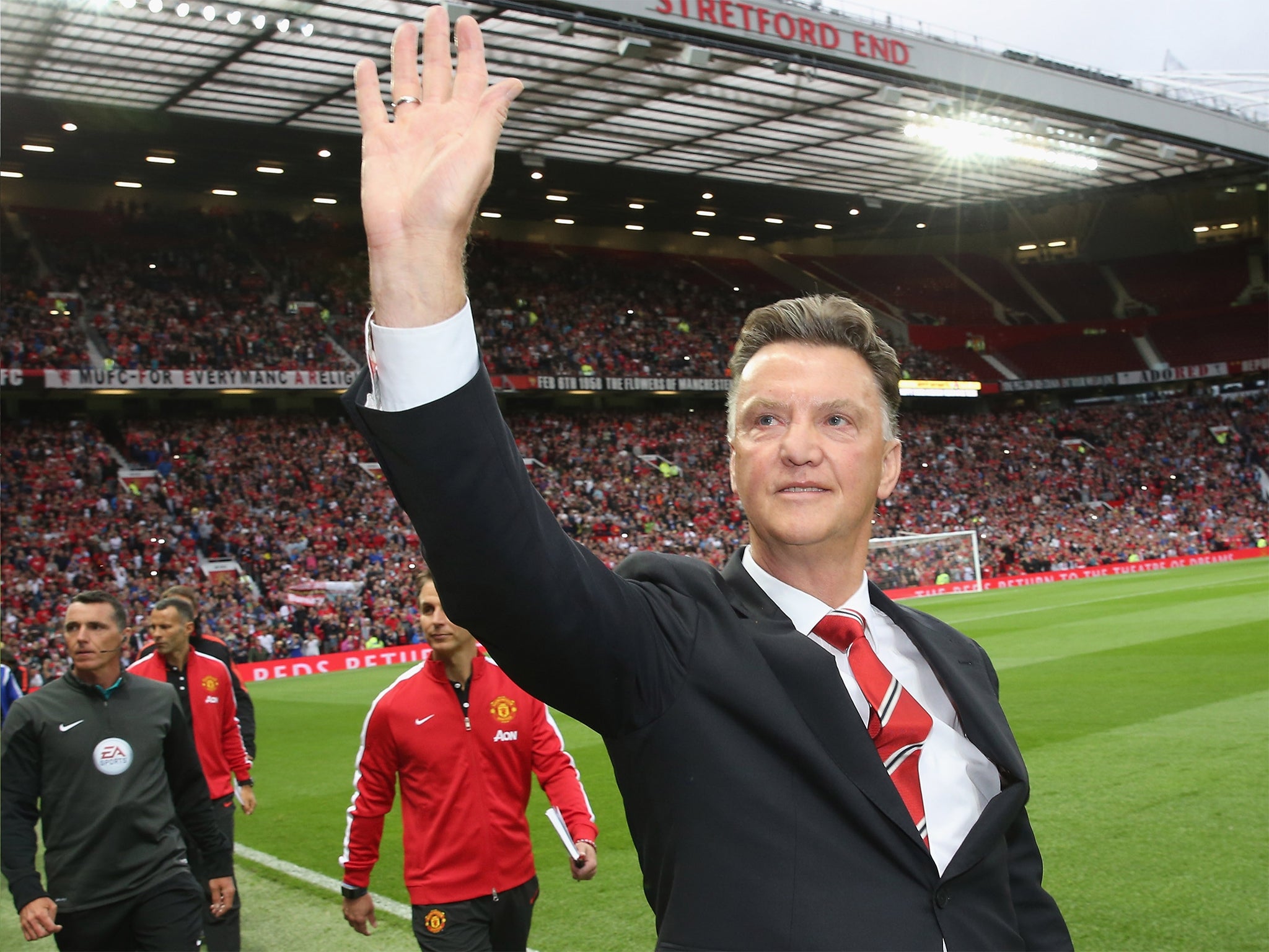 Louis van Gaal signs salutes United fans before the match