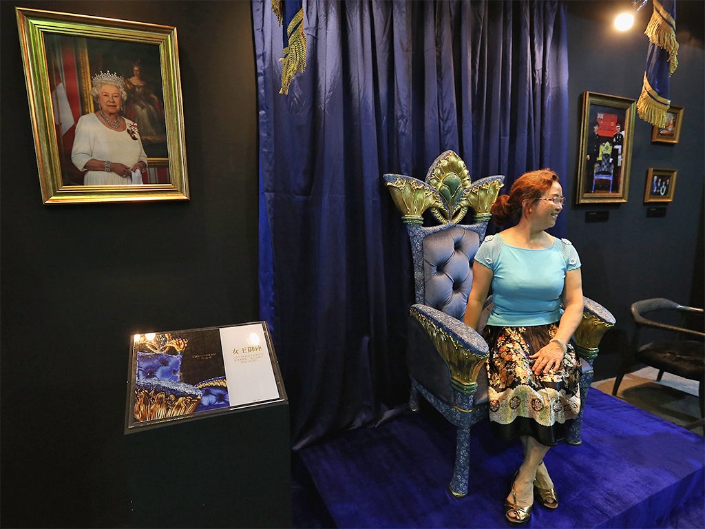 A shopper poses on an enamel throne at the Luxury China exhibition in Beijing. The ‘golden age’ of China’s luxury consumption is over – but brands are recovering