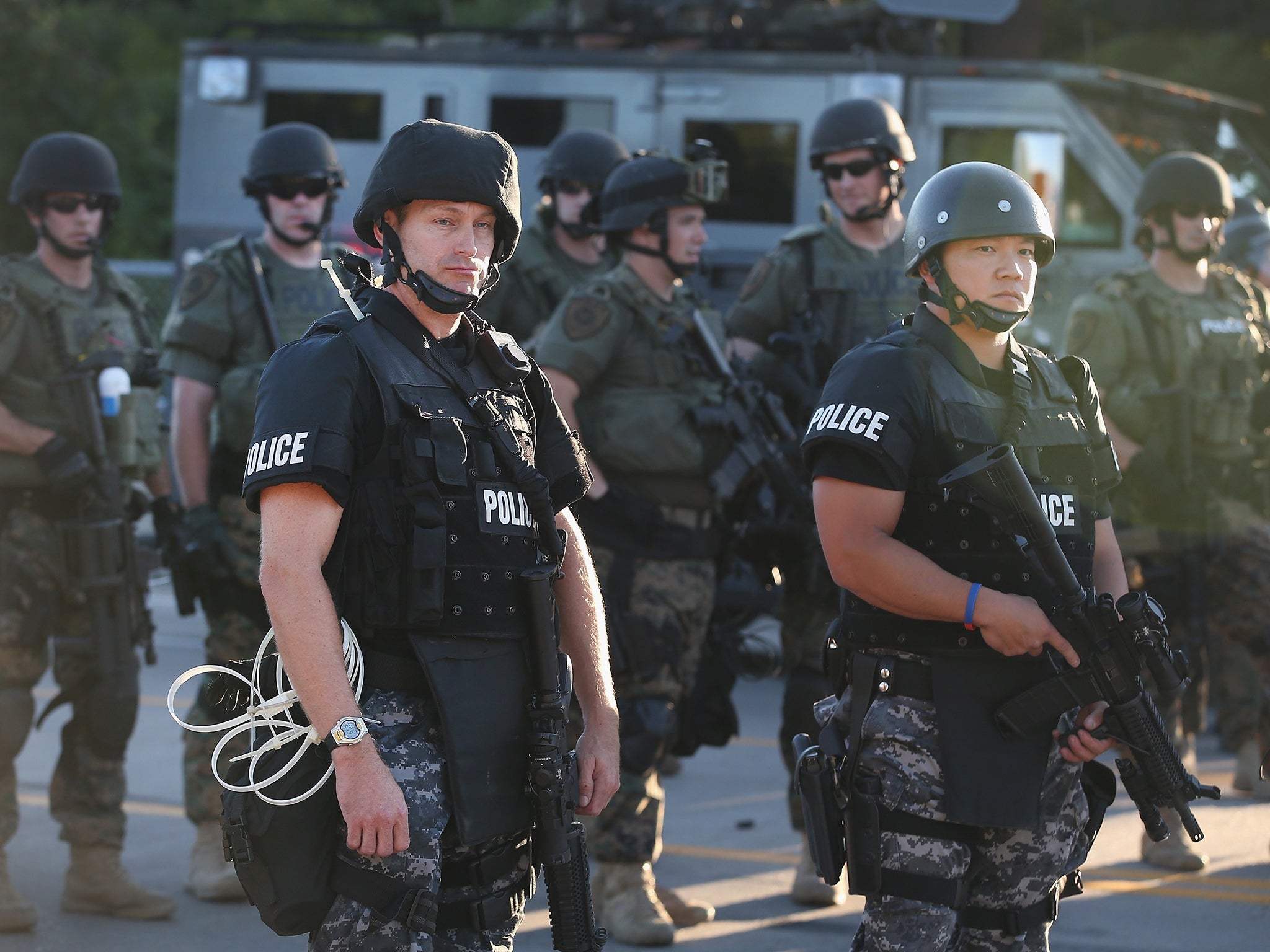 Police take up position to control demonstrators who were protesting the killing of teenager Michael Brown in Ferguson, Missouri