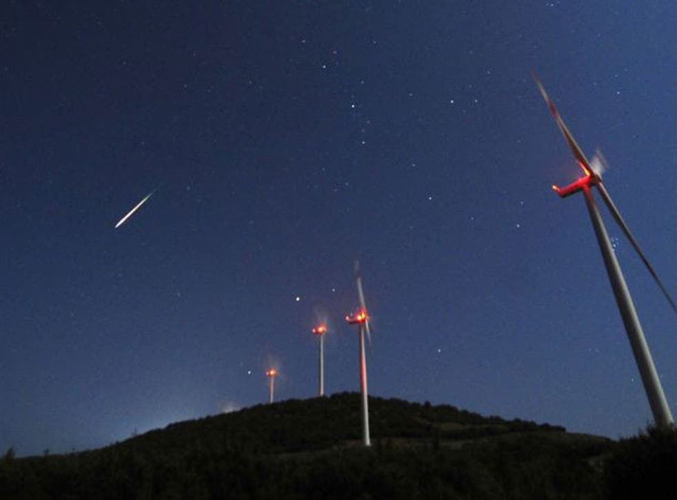 A meteor streaks across the sky during the Perseid Meteor Shower at a wind farm near Bogdanci, south of Skopje, Macedonia, in the early hours of 13 August