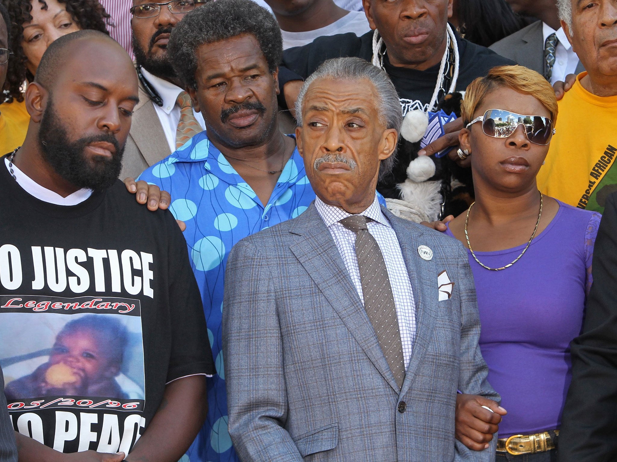 Michael Brown’s parents, Michael Brown Sr., left, and
Lesley McSpadden, right, stand next to the Rev Al
Sharpton in St Louis on Tuesday