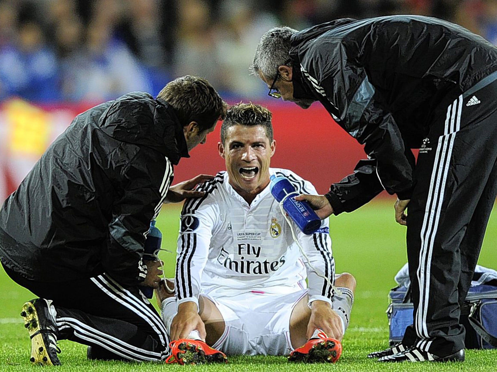Cristiano Ronaldo receives attention from Real Madrid physios during the Super Cup win over Seville
