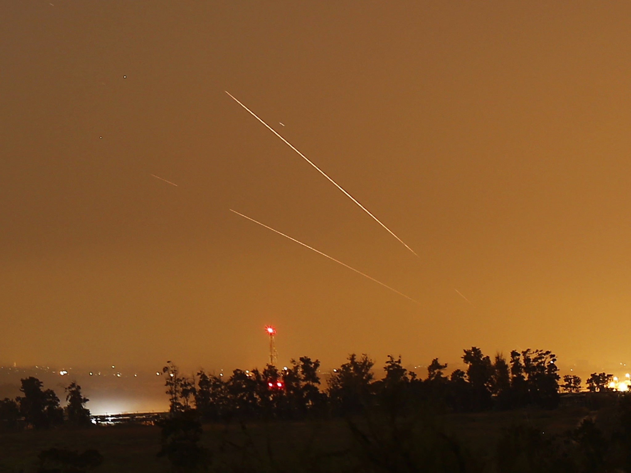 Light streaks and trails are seen as rockets are launched from Gaza towards Israel before a 72-hour cease fire was due to expire August 13, 2014