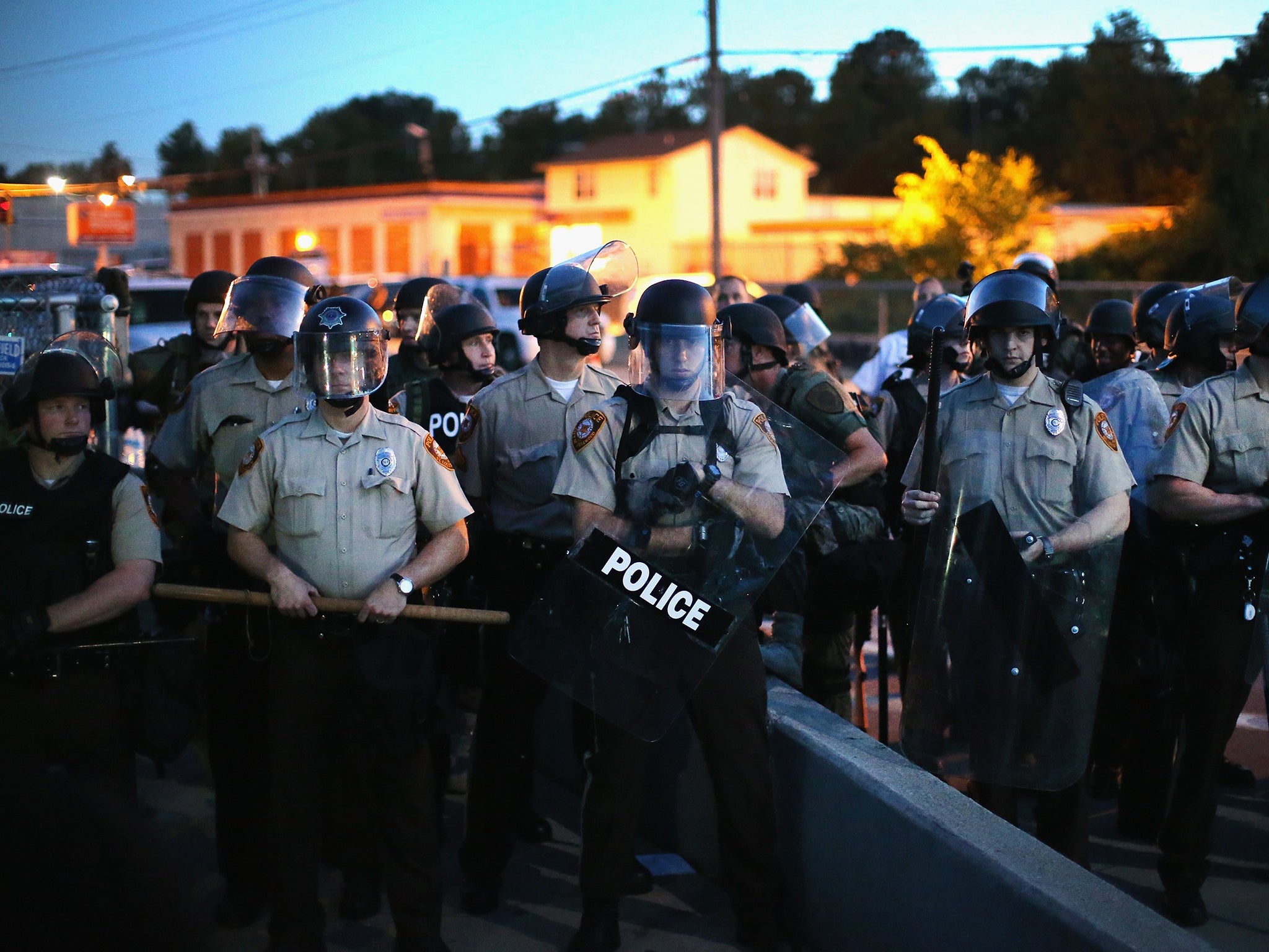 Police stand watch during the demonstrations. These are not the officers referred to in the report below