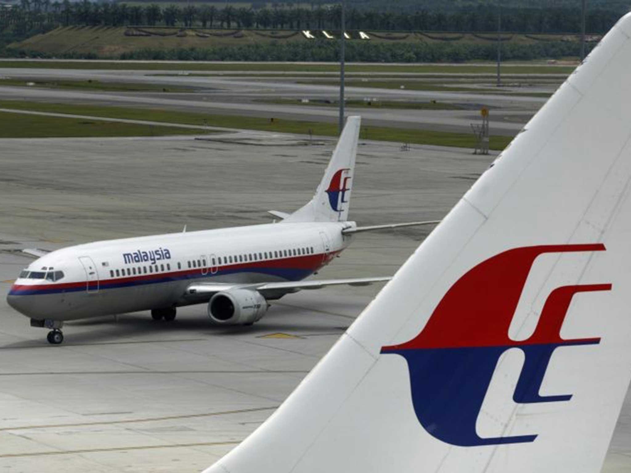 One of Malaysia Airlines carriers stands on the runway at Kuala Lumpar