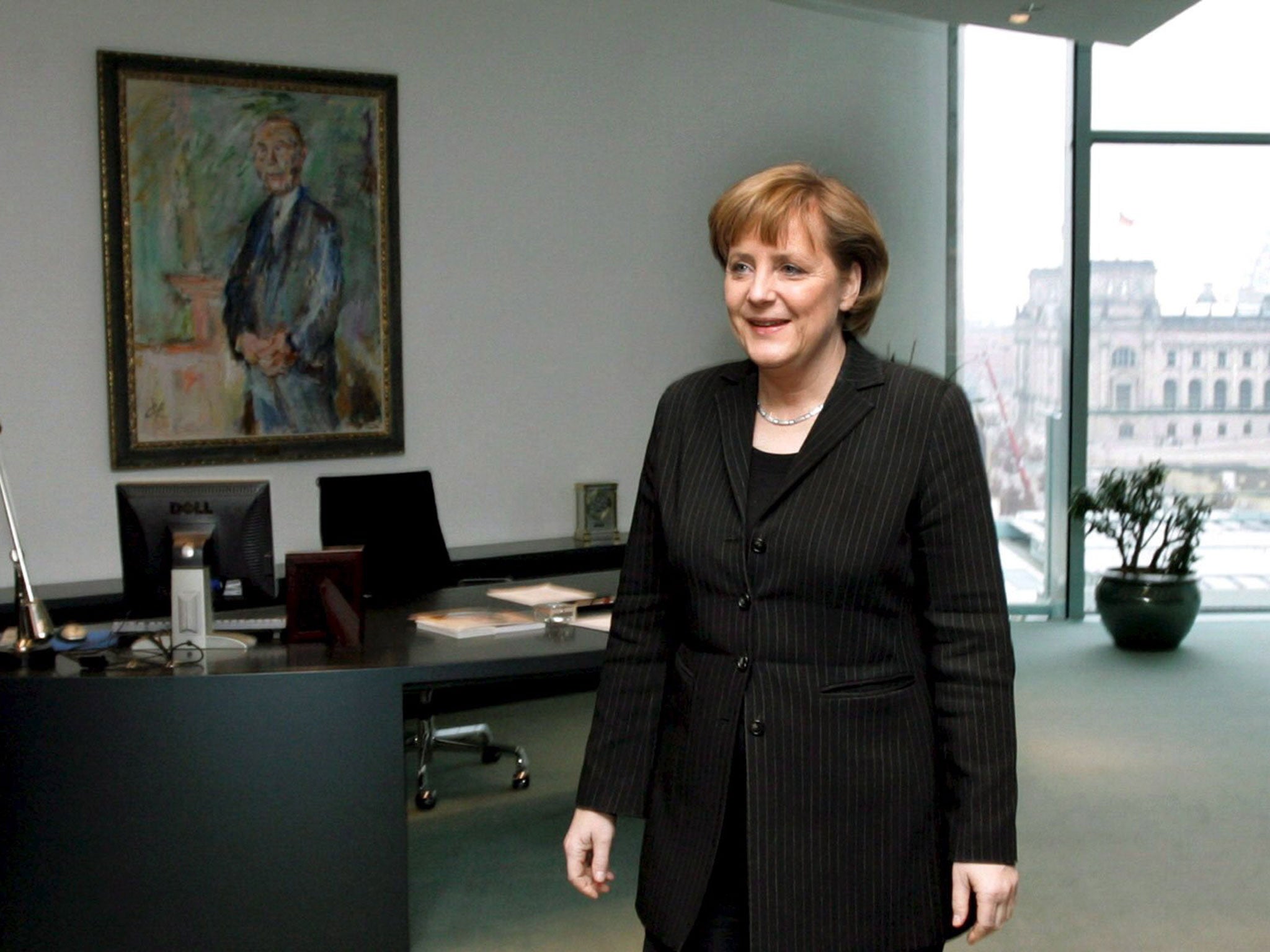 Seat of power: Angela Merkel prefers to use a small writing desk rather than Gerhard Schröder's behemoth