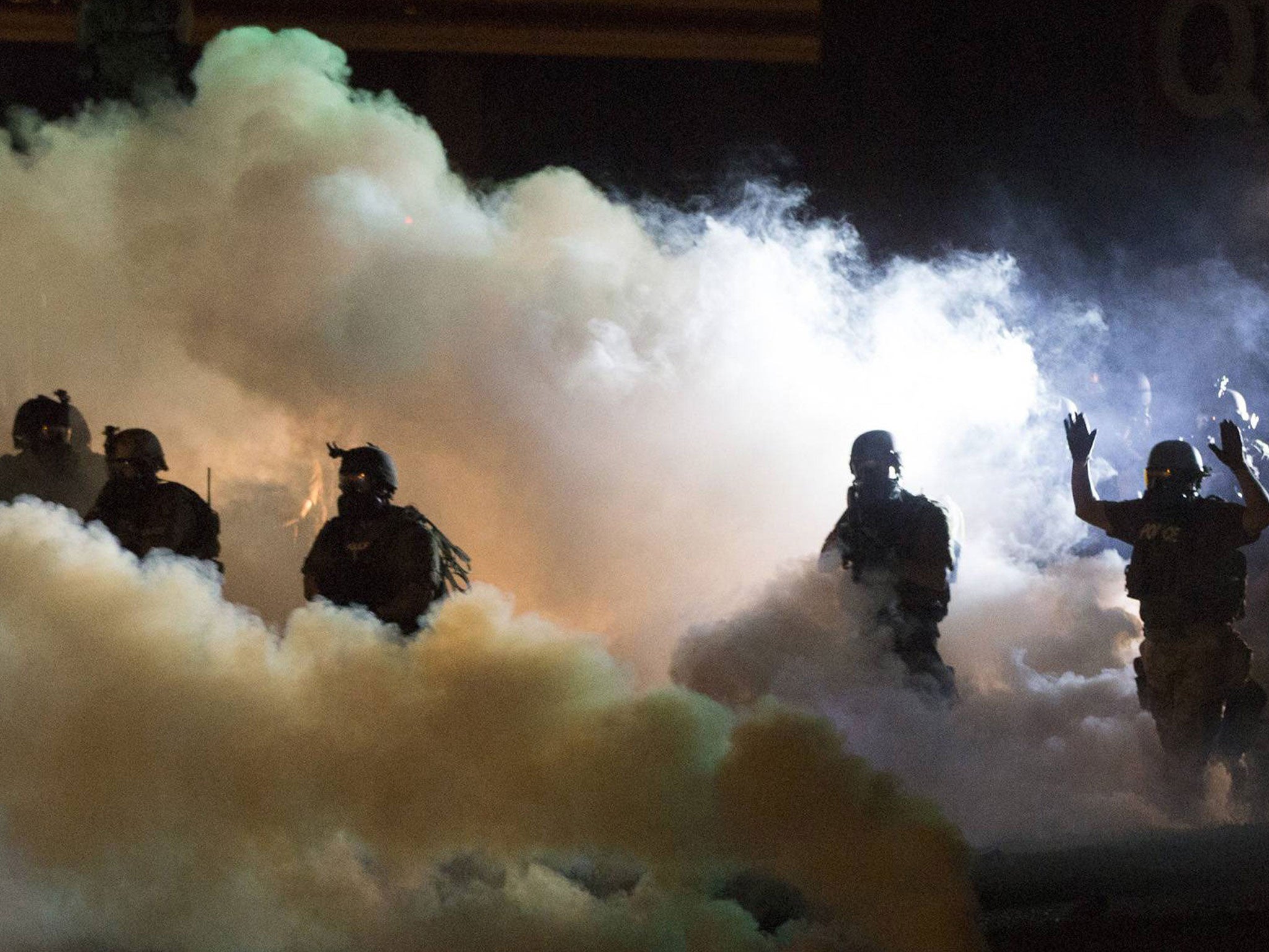 Riot police clear a street with smoke bombs while clashing with demonstrators in Ferguson, Missouri. State Senator Claire McCaskill has called for the ‘demilitarisation’ of the police response