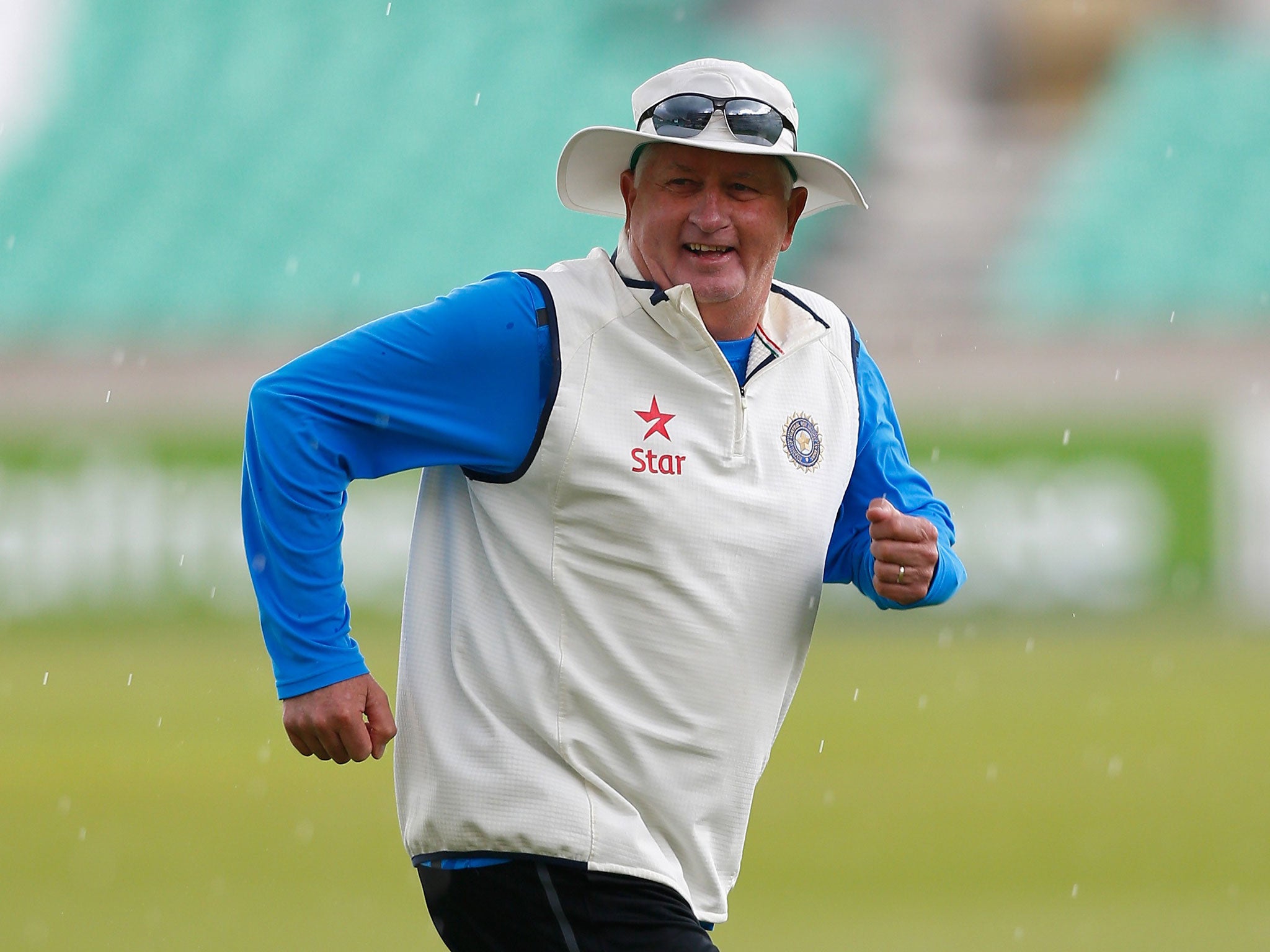 The India coach Duncan Fletcher runs for cover during a nets session at The Oval yesterday